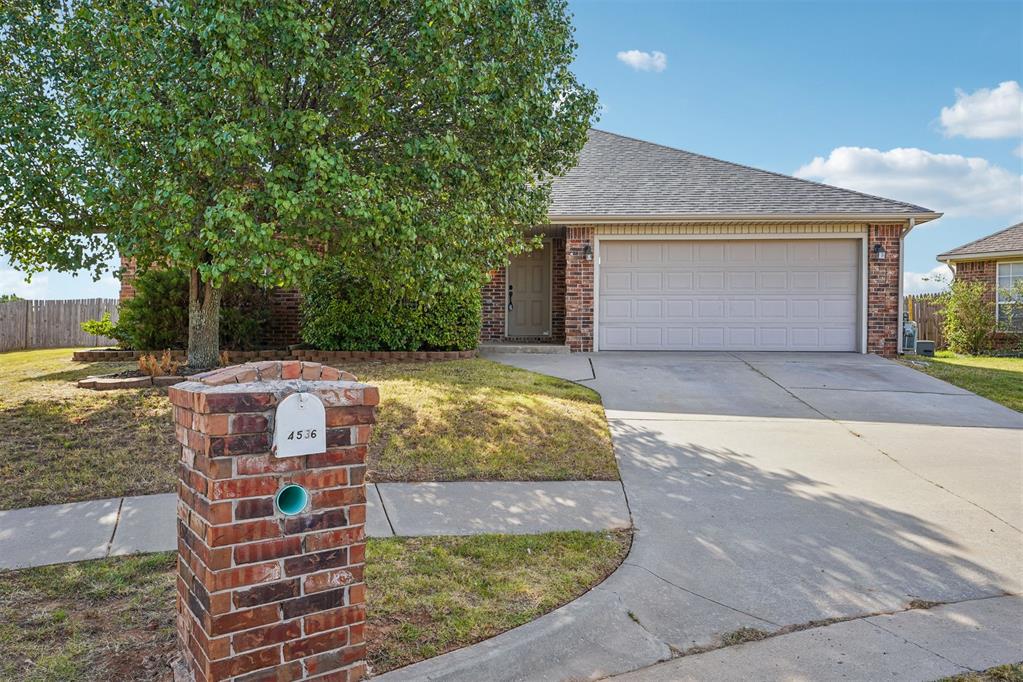 Tucked at the end of a cul-de-sac, this home offers an oversized backyard, fresh updates, and a functional four-bedroom layout. The interior has been freshly repainted throughout, including walls, ceilings, trim, doors, and cabinetry. The living room features wood-look laminate flooring and a brick fireplace, while the kitchen offers an eat-in dining area, pantry, and convenient access to the backyard. The primary suite includes a walk-in closet, double vanities, tiled shower, and separate jetted tub. Two secondary bedrooms and the hall bathroom are located together on their own hallway, while the fourth bedroom is positioned at the front of the home. Outside, enjoy a privacy-fenced backyard with a covered patio. Additional features include a storm shelter in the garage and a roof replaced in 2025.