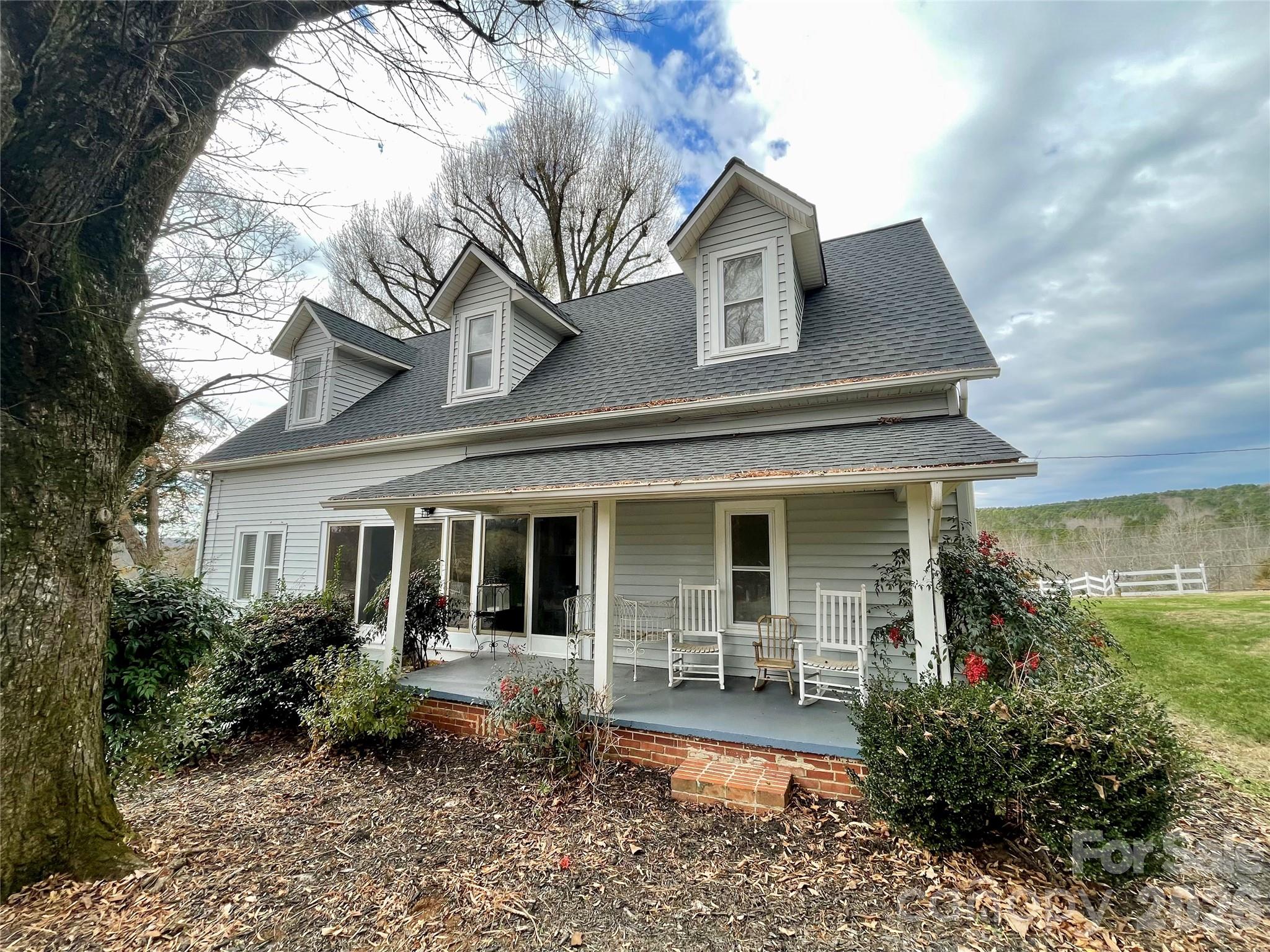 Beautiful 2300 sf, 2 story farmhouse on 15.86 acres in northwestern Stanly Co.  This is a dream opportunity for someone looking for a home on a nice tract of land in a peaceful community.  The house has 3 bedrooms, 3 full baths, an eat-in-kitchen, large dining room, a music room, 3 fireplaces and a large family room. The 3 bedrooms are upstairs, 1 being a large primary suite with a beautiful bath.  Besides the other 2 bedrooms upstairs there is an additional full bath.  The home also contains a sunroom & 2 covered porches perfect for sitting & having your favorite beverage.  Outside there numerous buildings including a cowbarn, a corncrib, sheds, an old washroom & detached double carport on a 26x30 concrete pad.  This property has approximately 1100 ft of road frontage, it is a special home you must see.  There is a old family cemetery on the property from previous owners.