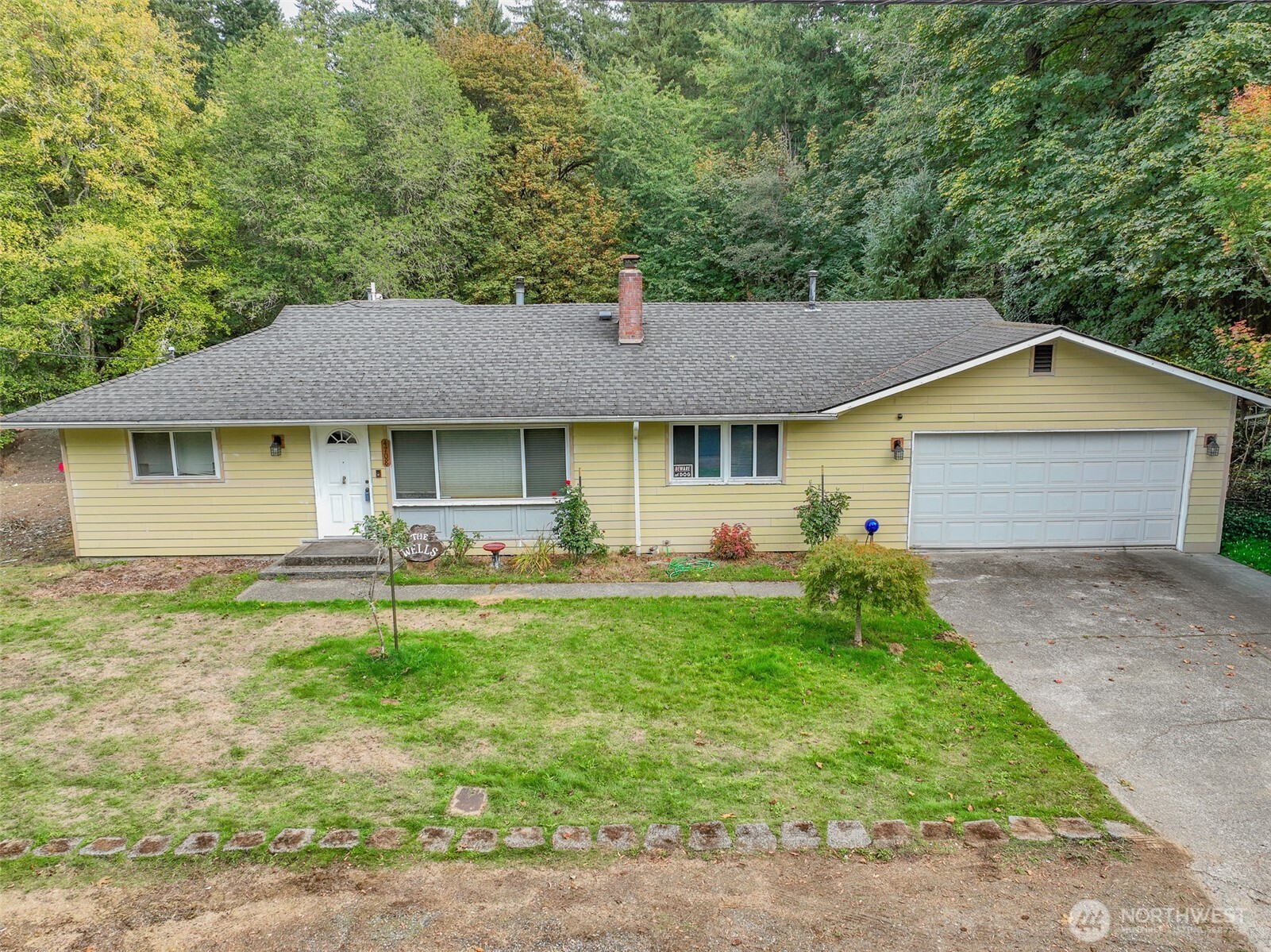 Prime opportunity in Tumwater! This well-located rambler sits on a quiet dead-end street just minutes from shopping, dining, and key amenitieS. The home features strong bones with original hardwood floors, a wood-burning fireplace, and a flexible layout including a bonus room that opens to a private raised deck. Additional value-add potential with a large garage, hobby/utility room, and half bath—great for workspace or conversion.  Mature trees add long-term curb appeal. Excellent candidate for a light renovation project in a high-demand area.
