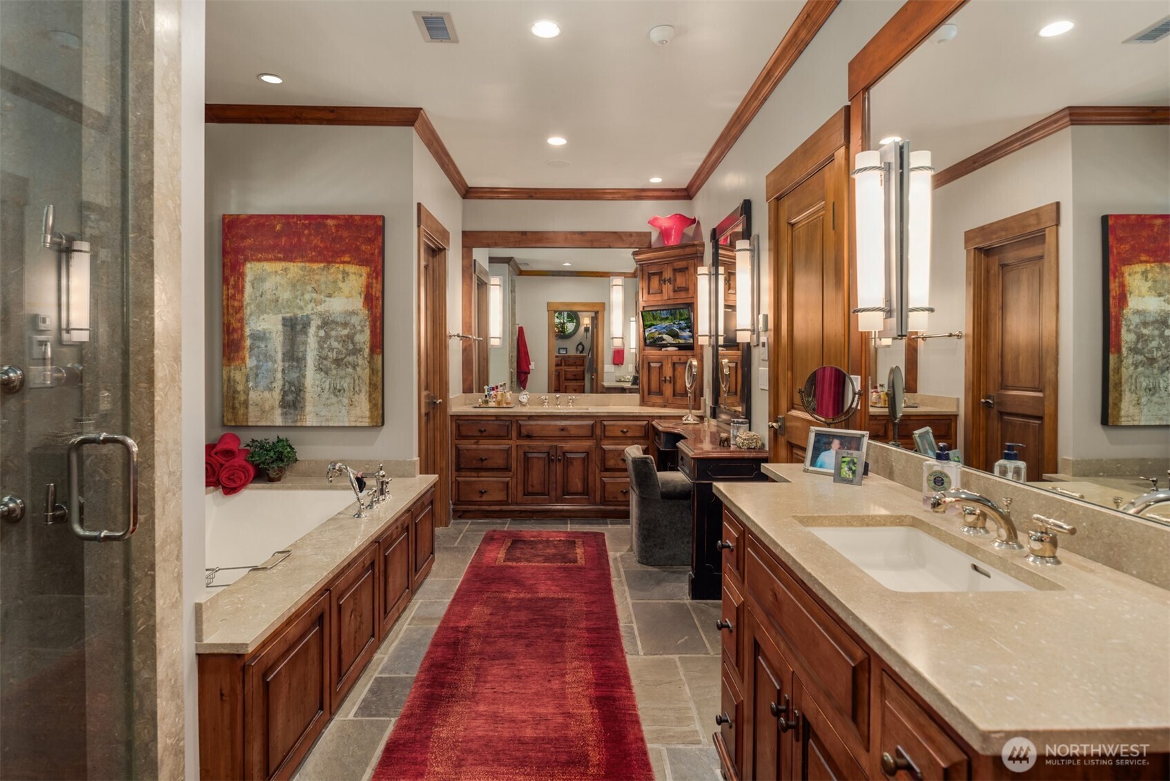 Primary bathroom with soaking tub, dual vanities, and makeup counter