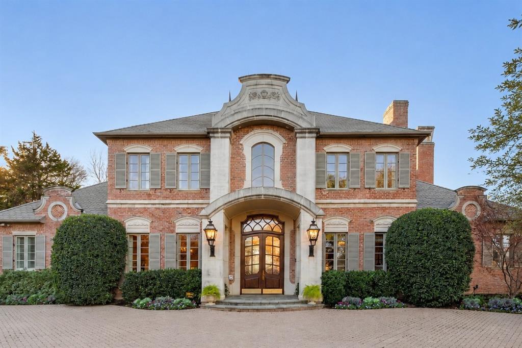 Ideally positioned in the heart of Arlington, home to FIFA World Cup 2026 events at AT&T Stadium, this offers an exceptional opportunity to own luxury real estate in one of North Texas' most internationally recognized destinations. This masterpiece was conceived as a French château, shaped by European architectural influence and designed for lasting comfort. Many of the home’s architectural elements were sourced from Europe and installed first, with the structure designed around them, giving the residence a collected, timeless presence. Set on two wooded acres along the West Fork of the Trinity River, the property offers rare privacy while remaining equidistant to Downtown Dallas and Fort Worth. Winding trails lead to the water’s edge, while the rear of the home overlooks Lake Viridian. The residence spans 9,026 square feet across three levels, with an additional 835 square feet of flexible upper-level space, all served by an elevator. The main living areas are climate controlled by a geothermal system, with traditional HVAC serving the garage and flex space. The main level features a grand entry with Versailles-inspired flooring, sweeping iron staircase, and crystal chandelier. A central parlor opens through imported French château doors to the veranda and is anchored by a Louis XIV limestone fireplace. The formal dining room, wet bar, office with Regency-era fireplace and London post-office doors, chef’s kitchen with a separate catering kitchen, and a private primary suite with dual baths and custom closets complete the main floor. The pool level includes a full kitchen, wine cellar, game or studio space, laundry, and direct access to the resort-style terrace. The upper level offers three bedrooms, two baths, catwalk views, and a balcony suite overlooking the estate. A rare blend of European architecture, privacy, and location in the heart of North Texas.