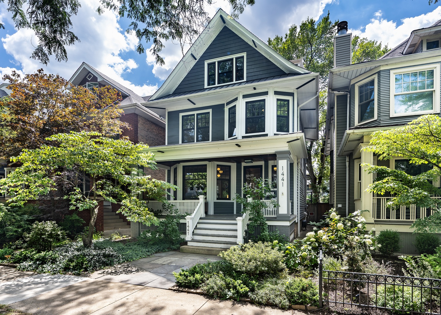 Beautifully reimagined and fully renovated in 2019, this Graceland West treasure sits on an extra-wide 30-foot lot, offering the perfect balance of space, function, and style. Flooded with natural light and finished with gleaming hardwood floors throughout, the thoughtful layout is designed for both everyday living and effortless entertaining. Step onto the inviting front porch and into a spacious living room that flows seamlessly into the dining area. At the heart of the home, the chef's kitchen impresses with a striking quartzite island, top-tier stainless steel appliances, and a garden window overlooking the professionally landscaped backyard. Designed for easy enjoyment with minimal upkeep, the outdoor space features a bluestone patio, brick walkways, premium turf, and a two-car garage. A stylish powder room completes the main level.  Upstairs, three generous bedrooms share a full bath, while the top level is reserved for the private primary retreat complete with a spa-like en-suite, two large walk-in closets, a cozy den, and a convenient washer/dryer. The lower level expands your living options with a spacious recreation room, a fifth bedroom ideal for guests or a home office, a second laundry area, and a private rear entrance.  Perfectly located in the sought-after Ravenswood School District and close to the shops, dining, and transit along the Southport and Montrose corridors, this rare find combines timeless design with modern comfort in one of Chicago's most beloved neighborhoods.