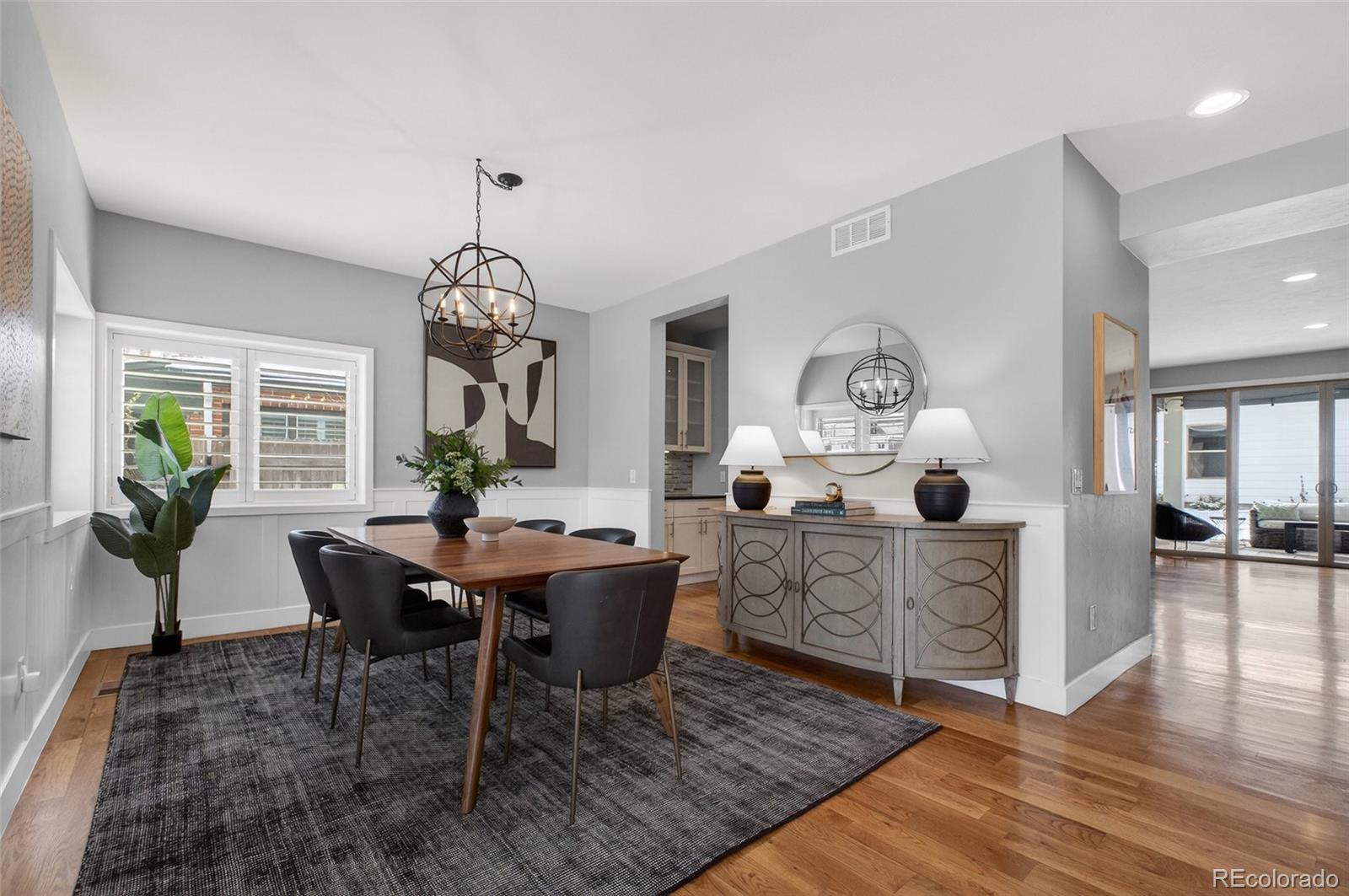 Modern sophistication meets unbeatable location in this stunning 2-story home, just blocks from everything you love about NW Denver. Nestled near Sloan’s Lake, the vibrant shops of 32nd Avenue, and an array of incredible dining, coffee spots, boutiques, yoga studios, brewpubs, and more, this property offers the ultimate lifestyle. Spend weekends at the local farmers market, art fairs, or community events, all while supporting a neighborhood brimming with locally owned businesses. The home’s exterior is a striking mix of stone, siding, and stucco, setting the tone for the modern elegance within. Open floor plan filled with natural light pouring through walls of windows. Hosting is a breeze, whether it's a lively dinner party in the spacious dining room, a casual meal at the kitchen’s bar seating for 4, or cocktails spilling out onto the expansive covered patio with see-through fireplace. Enjoy backyard summer BBQs or cozy evenings soaking in the hot tub. Chef’s kitchen w/ stainless appliances, double ovens, professional sized side-by-side refrigerator and freezer, and walk-in pantry. Warm wood cabinetry, pendant-lit island seating, and butler’s hall leading to the dining area make both everyday meals and entertaining effortless. Living area features a stunning floor-to-ceiling stone fireplace along with a built-in wet bar with wine/beverage fridge. Main-level office with glass French doors, built-in bookshelves and French doors from office to front patio for coffee or work in the shade of the aspen trees. Upstairs: the primary retreat w/ French doors, a 5-pc bath with heated floors, soaking tub w/double sided fireplace, walk-in closet, private balcony. 2 additional bedrooms on this level include one with its own balcony, and shared double vanity full bath. 2nd floor laundry room with a utility sink. Lower level: create a family room, media room, or workout space. Guest suite with full bath. 3-car garage wired for EV. This isn’t just a place to live, it’s a lifestyle.