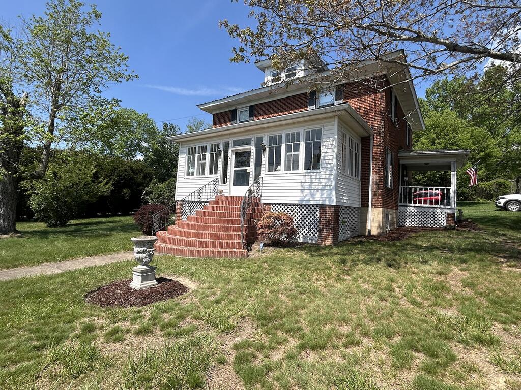 Step back in time to this 1900's brick 2-story home beaming with character. Inside you have 4 large bedrooms, 2 baths, Living room, den, dining area, kitchen and laundry along with a basement for storage.  Home has original wood and an enclosed front porch with an open side porch.  Outside you have trees for privacy along with a patio area and nice yard.  You even have a view of the mountains! This is a must see...call today!