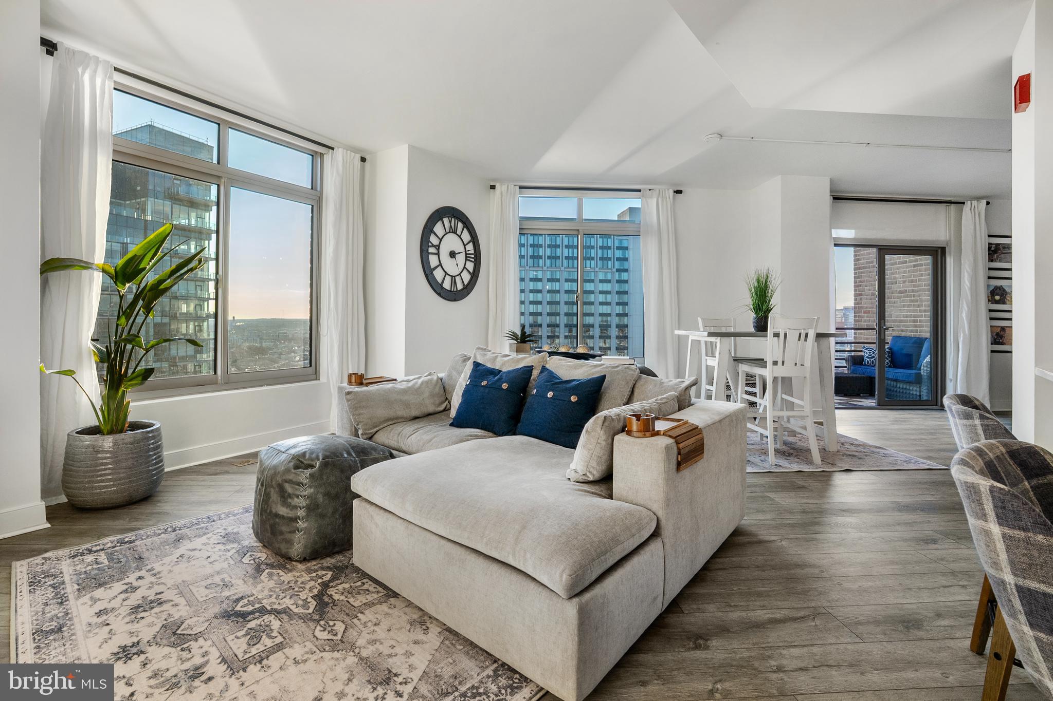 Sky-Level Luxury at The Vue | Harbor EastCommanding the 26th floor of The Vue, this extraordinary two-bedroom, two-bath sky residence offers a rare opportunity to own one of Harbor East’s coveted water-facing homes. Framed by expansive windows, the residence captures sweeping, unobstructed panoramas of Baltimore’s iconic skyline and shimmering waterfront—creating a constantly evolving backdrop of light, water, and city energy.The home’s open, light-filled design blends modern sophistication with effortless livability. At its heart, the newer reimagined chef’s kitchen is both stunning and functional, anchored by an expansive quartz island and complemented by a refined subway tile backsplash, sculptural range hood, and integrated Microwave Drawer. This condo boasts new LVP flooring throughout. Whether hosting intimate gatherings or enjoying a quiet morning coffee, every detail has been thoughtfully curated.Step onto the private balcony and experience Harbor East from above—where golden sunsets melt into city lights and the harbor reflects the rhythm of Baltimore below.The primary suite is a serene sanctuary, offering new gorgeous plantation shutters, a walk-in closet and a completely-renovated spa-inspired bath designed for relaxation, complete with a glass-enclosed shower and elegant double vanity. A beautifully appointed guest suite with new remote-controlled blinds, its own custom walk-in closet and newly-renovated full bath provides comfort and privacy for visitors or serves as an ideal executive office.One covered parking space conveys with the residence.Life at The Vue offers a seamless blend of luxury, convenience, and security. Residents enjoy full-service amenities including front desk concierge, package acceptance, onsite management, and comprehensive building services. The monthly condominium fee includes heating, air conditioning, hot water, water, sewer, and building maintenance.Private elevator access connects residents to the exclusive 8th-floor outdoor green space—an elevated urban retreat—as well as direct access to the MAC fitness center and Harbor East Cinemas. Just beyond your door awaits Harbor East’s premier collection of fine dining, boutique shopping, Whole Foods, waterfront promenades, and vibrant nightlife.This is more than a residence. It is a vantage point above the city—and a lifestyle without compromise.