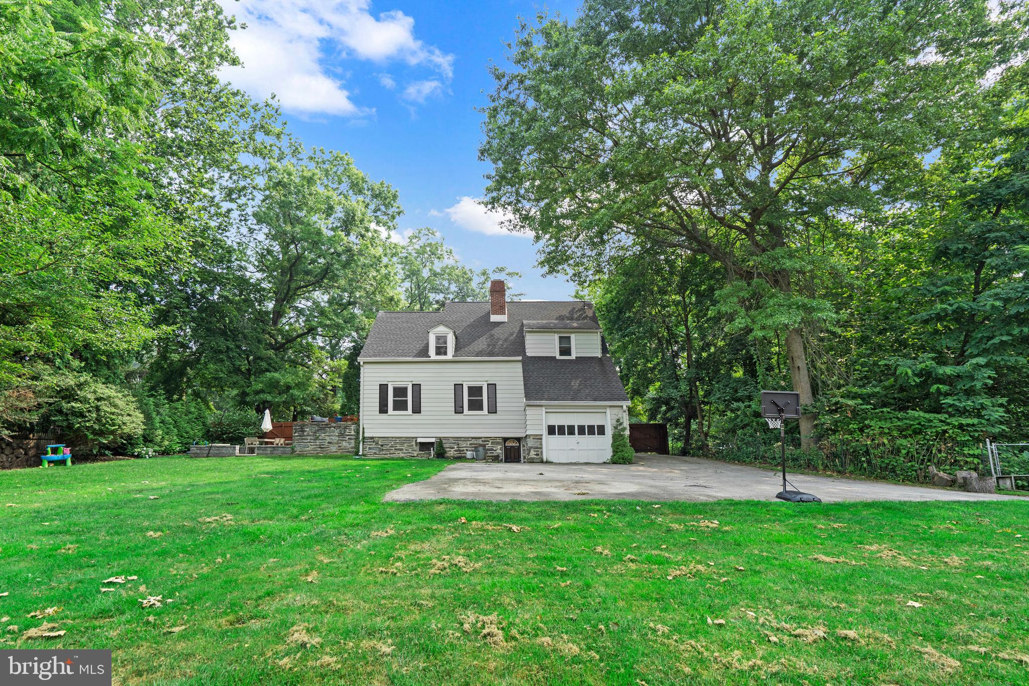 Welcome home to 594 Haverford Road, a timeless Cape Cod that perfectly blends classic charm with thoughtful modern updates and over 2,000sq ft of finished living space. Filled with character, abundant natural light, and nestled in one of Haverford’s most convenient locations, this move-in ready home offers the best of both worlds.From the moment you arrive, the inviting covered front porch and gated driveway set the tone for the warmth and care found throughout the property. Recent improvements—including a newer roof, newer windows, newer HVAC, a recently installed privacy fence, and gorgeous hardwood floors—provide peace of mind while preserving the home’s timeless appeal.Step inside to a spacious foyer with a large closet and convenient powder room before entering the expansive living room, where a stunning fireplace creates a warm and welcoming focal point. Entertaining is effortless thanks to direct access from the living room to a beautiful stone patio, which flows down to an expansive lower patio with newer pavers—creating two exceptional outdoor living spaces perfect for gatherings or relaxing outdoors.The main level also features a gracious formal dining room and a bright kitchen with beautiful wood cabinetry, newer stainless steel appliances, and plenty of workspace. Just off the kitchen, you’ll find a practical mudroom and pantry area offering exceptional storage, along with access to the recently finished lower level. The basement provides flexible living space, direct access to the backyard, a dedicated laundry area with additional storage.Upstairs are three generously sized bedrooms, all showcasing gorgeous hardwood floors and wonderful natural light. The primary bedroom features double closets, while the hall bath offers timeless black-and-white tile. A large walk-in storage closet adds even more functionality to the second floor.Situated on nearly one-third of an acre, the level lot offers plenty of room to enjoy the outdoors. The oversized driveway features a convenient turnaround and leads to a detached one-car garage. Located directly across from the scenic Haverford College Nature Trail, the home enjoys a peaceful, private setting while remaining just moments from everything. Walk to the train station, highly regarded local schools, parks, shopping, and dining, making everyday living as convenient as it is enjoyable.Classic character, exceptional outdoor spaces, extensive updates, and an unbeatable Haverford location make 594 Haverford Road a truly special place to call home.