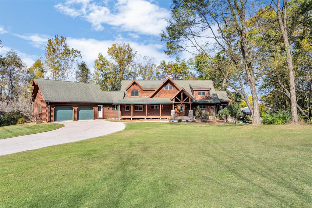Beautiful Custom Log Home on All Sports Lake Le Ann South.Come enjoy this beautiful lake in the ''Grandest Of Fashion''Built in 2001, this magnificent lakefront property has awe inspiring cathedral ceilings throughout, complete open floor plan with beautiful lake views and 177 feet of water frontage.Located on a 0.66 acre lot on a quiet cul-de-sac, this home welcomes you with a large front porch area boasting well crafted fieldstone pillars and  8'' Swedish pine logs. Entering this warm and inviting home you will experience a very welcoming and spacious foyer area with half bathroom. The incredible open floor plan draws you into a great room that has a total WOW! factor.Custom fieldstone wood burning fireplace and chimney that effortlessly blends into the wooden logs and soaring structure of this home. Andersen windows throughout the home with a sun tint added to the expansive A frame windows in the great room. Great open kitchen area with recess and pendant lighting, custom cabinets, center island, pantry, breakfast bar and built in desk option. Decagon shaped dining room with panoramic views. The main floor also offers a very large primary bedroom with full bathroom and spacious walk-in closet, separate laundry room, mud room and full bath. The well crafted staircase leads you to the 2nd level where you experience a sizable open library / loft area that give you wonderful lake views, a private office area overlooking the main floor primary suite, large 2nd & 3rd bedrooms with double closets and an additional full bathroom. Lower walkout area has an abundance of room for entertaining with a bar area, a Caribbean ocean themed game room, storage room & utility room. Gen/ Tran whole home generator hook up, Geothermal heat system, 2.5 Car garage with additional area above currently used for storage but could be developed into additional living space.
Additional Features Include: Large decks, patio, 6 person hot tub, heated driveway, additional parking area / basketball court, outdoor fire pit, boardwalk dock area wi