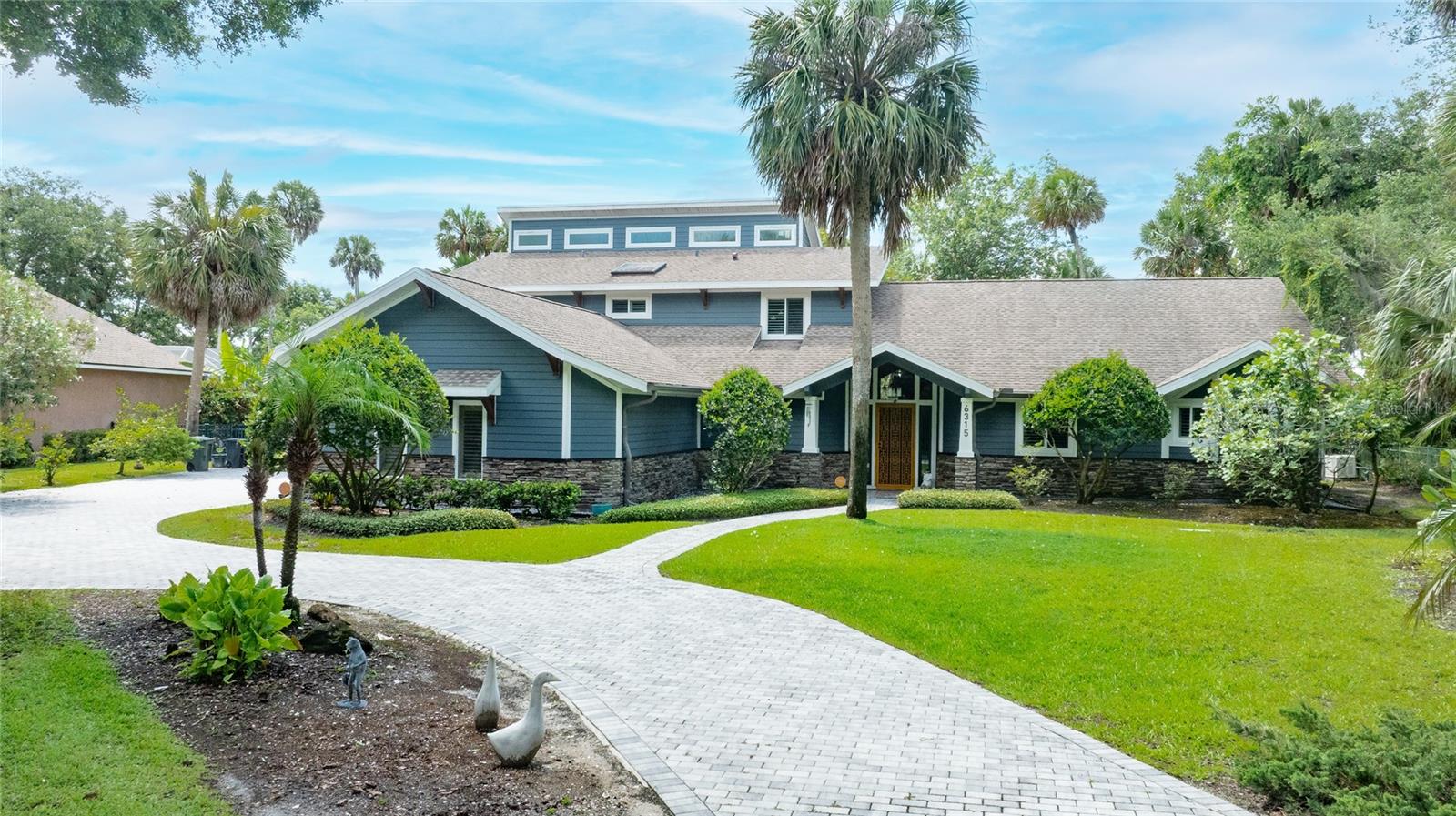 Welcome to Palmas Bay, one of Port Orange's most desirable gated waterfront communities. This custom riverfront home offers the kind of views and privacy that are becoming harder to find. Situated across from the protected Doris Leeper Preserve, you'll enjoy a natural backdrop with no homes or future development across the water—just endless views, wildlife, beautiful sunsets, and the peaceful Florida lifestyle you have been dreaming about.With 4 bedrooms, 4.5 bathrooms, and an expansive 3-car garage, the home is thoughtfully designed to accommodate everyday living, visiting guests, hobbies, and effortless entertaining. The versatile floor plan features a private downstairs guest suite with its own bathroom, an additional guest bedroom, and a convenient pool-access half bath that makes indoor-outdoor living easy.The kitchen flows naturally into the family room, creating an inviting central gathering area framed by a fireplace and tranquil water views. Nearby, a light-filled sunroom offers the perfect spot to sip morning coffee while boats drift along the river. The main level also includes a generous formal living room, ideal for hosting holidays, celebrations, and memorable get-togethers.The primary suite is tucked away upstairs and feels like a private retreat. Features include a fireplace, private office, oversized walk-in closets, double vanity, and a private balcony overlooking the backyard and river. An adjoining fourth bedroom provides flexibility for a nursery, fitness room, second office, sitting room, or additional guest space.Step outside and discover what makes this property truly special. The backyard was designed to enjoy waterfront living with a private dock, pool, spa, multiple firepit areas, mature landscaping, storage shed, and a unique treehouse that could be used as a play space, art studio, reading retreat, or creative workspace.Whether you enjoy boating, kayaking, paddleboarding, fishing, entertaining friends, or simply relaxing by the water, this property offers something for everyone. The oversized garage provides plenty of room for vehicles, golf carts, tools, and recreational equipment.Palmas Bay is known for its beautiful waterfront homes, privacy, and convenient location near shopping, dining, golf courses, medical facilities, and some of Central Florida's most beautiful beaches. You're just minutes from New Smyrna Beach, Daytona Beach Shores, Ponce Inlet, and all the outdoor recreation the area has to offer.Properties with protected preserve views, private docks, flexible living spaces, and this much outdoor enjoyment rarely become available. If you've been searching for a true waterfront estate with room to spread out, entertain, and enjoy everything Florida living has to offer, this home deserves a closer look.