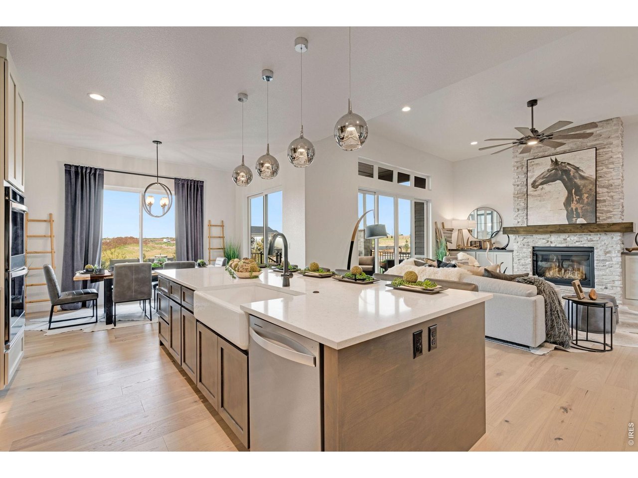 Take advantage of a $15,000 Builder Incentive on this Now Available - Former Model Home! The Remington by Bridgewater Homes. Experience multi generation living in this immaculate 2-story Remington Model Home, crafted by renowned local builder Bridgewater Homes. This beautifully upgraded model showcases the finest in quality construction and high-end finishes throughout. Boasting a split garage w/private entrance to main floor on-suite, this 6 bedroom, 4.5 bathroom, and a main floor office, offers space for everyone - including a fully finished garden level basement with a beautiful wet bar. Premium features include: Engineered hardwood flooring, Gourmet kitchen with gas range, double ovens, slab quartz counters, and custom Tharp cabinets. Large walk-in pantry and functional mudroom. Cozy gas fireplace and designer touches throughout. Retreat to the luxurious primary suite with a spa-inspired 5-piece bath and walk-in closet. Convenient upstairs laundry, central A/C, whole-home humidifier, and 2x6 exterior walls for energy efficiency add to the comfort and value. Outside, enjoy the beautifully landscaped front and back yards, a 12' x 18' covered deck. Located in The Aurora Highlands with easy access to top schools, shopping, Denver International Airport, and commuter routes. Don't miss your chance to own the Remington-schedule your private showing today!