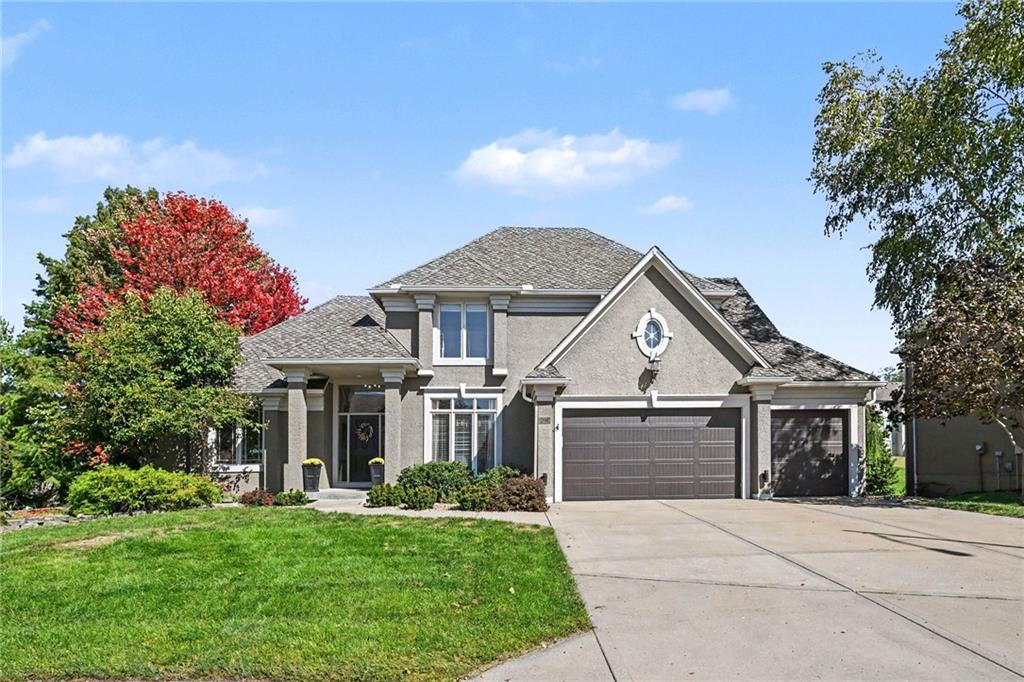 Beautifully updated 1.5-story Don Julian-built home tucked away on a desirable cul-de-sac lot in sought-after Riss Lake! Large, level driveway and open, park-like backyard are a rare find in this community! Thoughtfully updated throughout, the main level features ALL wood floors, updated fixtures, granite countertops in kitchen and ALL bathrooms, and fresh paint throughout—including walls, trim, doors, molding and cabinets. Impressive eat-in hearth kitchen features its own fireplace, abundant cabinetry with indirect lighting, two islands, pantry and an oversized breakfast bar.  Main-level office with glass pocket doors is conveniently located off the kitchen, which opens to an expansive deck with stairs leading to the lower patio, pergola and treed backyard. Main-level primary suite offers a lighted tray ceiling, bay windows, walk-in closet and an updated bathroom featuring dual vanity with granite, tile, separate shower and soaking tub. Upstairs, three generously sized bedrooms include one with an ensuite bath and two connected by a shared bath. Finished walkout lower level provides an incredible amount of additional living and entertaining space, featuring a wet bar with plenty of bar seating, rec room with fireplace, family room, fifth bedroom with granite study area and full bathroom. The lower level opens directly to the patio with multiple seating areas, extending the home's living and entertaining space outdoors.  Additional updates include NEW 50-year composition roof, garage doors and spacious storage with built-in shelving. All of this located in Riss Lake, offering three pools, tennis/pickleball courts, nature trails, a 134-acre fishing lake with dock access, playground, sand volleyball and basketball courts. Conveniently located just minutes from shopping, restaurants, groceries and historic downtown Parkville, with easy access to major highways for a quick commute!