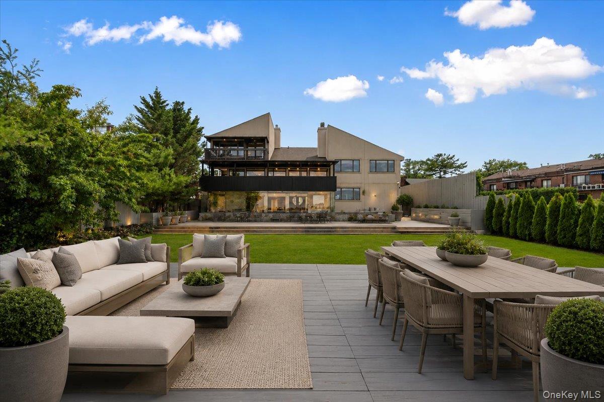 Set behind private gates on an oversized waterfront parcel, this extraordinary contemporary estate is a rare offering where architectural sophistication and resort-style living converge. Showcasing panoramic water views from every level, this one-of-a-kind residence delivers an unparalleled lifestyle of luxury, privacy, and tranquility.Designed with exceptional attention to detail, the home features 3 spacious bedrooms and 3.5 designer bathrooms, complemented by expansive entertaining spaces curated for both intimate gatherings and grand-scale hosting. The third level offers three beautifully appointed bedrooms, including one with a loft currently configured as a private fitness retreat. Occupying its own exclusive fourth floor, the lavish primary suite is a sanctuary unto itself, complete with a private waterfront balcony with amazing views of The Throgs Neck Bridge, oversized custom dressing room, and a spa-inspired marble bath with Jacuzzi tub overlooking the water. The residence seamlessly blends indoor and outdoor living. A stunning enclosed glass lounge with a sophisticated wet bar opens to an extraordinary waterfront patio featuring a built-in hot tub spa, creating the ultimate setting for entertaining against a breathtaking backdrop. Multiple terraces and decks throughout the property capture spectacular sunsets and endless water views. At the heart of the home is a chef’s kitchen designed to impress, featuring elegant Quartz countertops, premium stainless steel appliances, a center island, and a sunlit dining area. Bespoke finishes and artisan-crafted details are showcased throughout, including etched glass door inserts, custom storage solutions, cedar closets, and two working fireplaces that add warmth and character to the home’s refined aesthetic. Additional highlights include a third-floor laundry room, attached two-car garage, and ample parking for six or more vehicles. Offered fully furnished, this diamond-condition estate embodies effortless luxury — where every day feels like a private waterfront escape. A truly exceptional offering for the most discerning buyer.