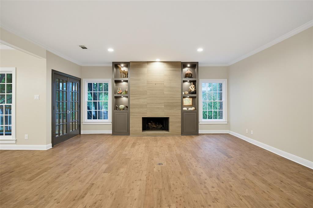 What an opportunity to own an exceptional front corner one-story residence in the coveted 19-unit Savoy Condominium in Highland Park and renown Highland Park ISD. On a tree lined street, welcome to “lock and leave” living in a home with traditional charm, modern updates, and thoughtful design. A convenient location within walking distance of shops, dining, and Whole Foods, enjoy living in the Town of Highland Park with exceptional city services (police, fire, EMS), five parks, tennis courts, swimming pool, and public library--near iconic Highland Park Village and minutes from Downtown Dallas and Love Field.  One of only six front corner units, this 2,033-square foot home has a smartly curated floor plan that provides effortless living and entertaining. The open design with hardwood floors offers an abundance of natural light throughout with tall windows and outdoor views on three sides. The private covered front terrace balcony in the treetops is off a gracious living room with fireplace and wet bar (with beverage refrigerator) opening into the dining room with exquisite chandelier. A “cook’s” kitchen with kitchen island features granite countertops, granite and tile backsplash, solid wood cabinetry, stainless appliances plus pantry and utility closet with stack washer and dryer. The spacious primary bedroom enjoys a sitting area and large walk-in closet. An ensuite spa-like bath is designed with marble counters and floors; large soaking tub; separate glass shower; and modern lighting and fixtures. Two more updated bedrooms (one with ensuite full bath with marble), and a lovely half bath, with custom tile and marble, complete the great floor plan. The third bedroom could be a great study or home office. Each resident has two designated storage closets and two parking spaces in the underground garage easily accessed by elevator. The Savoy in Highland Park makes living easy!