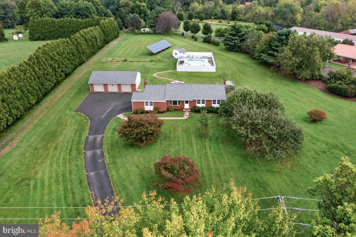 Owned by the same owner for 29 years and tucked into the award-winning Owen J. Roberts School District, 805 Ellis Woods Road has been steadily improved with the kind of practical, thoughtful upgrades that come from really knowing and enjoying a home. Set on a spacious 2-acre lot with mature trees, incredible privacy, a heated in-ground pool with hot tub, a huge brick patio, outdoor kitchen-style grilling area, and a large detached three-car garage, this property brings together comfort, function, and a whole lot of fun.And honestly, the backyard may steal the show.This is the kind of outdoor setup that makes you want to cancel your weekend plans and stay home. The expansive paver patio offers tons of room for dining, lounging, and entertaining, while the built-in grilling area creates an outdoor kitchen feel that makes summer dinners ridiculously easy. Just beyond is the private heated pool and hot tub, surrounded by mature landscaping and enough space to make a regular Tuesday feel a little like vacation. The pool equipment is thoughtfully housed in its own pool house shed, keeping it protected from the elements and helping extend it's life. Pool parties, cookouts, lazy afternoons, late-night hot tub hangs - you’ve got the setup for all of it, right in your own backyard.Inside, the home's two main living spaces give you plenty of room to gather, relax, and spread out. One features a wood-burning fireplace that creates a cozy natural gathering spot, while the other is filled with natural light from a bay window overlooking the front yard. The kitchen is functional and ready to be reimagined, giving the next owner an opportunity to create a space that suits the way they live today. Just beyond, the dining room opens directly to that fabulous patio, making indoor-outdoor entertaining wonderfully easy.A full hall bath serves two comfortable bedrooms, while the primary bedroom includes its own private full bath and a particularly fun bonus - direct access to the patio. Morning coffee outside? Midnight dip in the pool? Hot tub before bed? No need to wander through the rest of the house.The finished basement adds another layer of flexibility with plenty of room for recreation, hobbies, a home office, or simply the overflow of everyday life.And then there's the garage. This fantastically large detached three-car garage offers a delightful amount of space for vehicles, storage, a workshop, hobbies, toys, or whatever your particular version of "we need more room" happens to be.There's also plenty happening behind the scenes. Owned solar panels help offset the home's electrical usage (and for all you well-versed energy nerds, they produce roughly 12 MWh of electricity each year); SRECs are not currently under contract, so they'll be available to the new owner. A geothermal heat pump provides efficient heating and cooling, plus an updated electrical panel, new carpet, fresh paint, and a brand-new roof add to the home's comfort, function, and long-term value.805 Ellis Woods Road offers something increasingly hard to find: 2 private acres, great bones, meaningful improvements, an enormous garage, and an outdoor living space that feels like your own little summer resort. There's still plenty of opportunity to make the home your own - but the pool, hot tub, patio, grill, privacy, and room to play? That part is already pretty fantastic.Conveniently located next to Ellis Woods Park which is now officially a Wildlife Habitat. The 71-acre park includes woods, meadows, wetlands, and cultivated farmland, with more than 100 varieties of birds to spot, along with small mammals, reptiles, and amphibians. Plus, the Schuykill River Trail is short 2 mile drive ...Nature lovers rejoice!