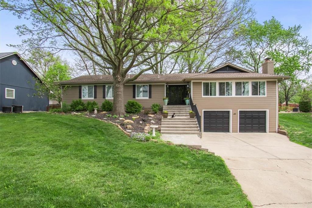 Experience the sought-after lake lifestyle in this thoughtfully updated ranch, situated on a 0.3-acre lot with a park-like atmosphere created by towering mature trees. This home offers a warm, functional layout with inviting spaces throughout. The heart of the residence is the updated kitchen, which features a deep farmhouse sink, granite countertops, custom cabinetry, and a stainless steel appliance package. High-quality finishes like the hardwood flooring and the bright white plank ceilings in the main living areas add a touch of modern character, while a classic masonry fireplace serves as a cozy focal point in the living room.The main level includes comfortable bedrooms and a full bathroom featuring custom tile work and a modern vessel sink. Below, the finished basement provides a large secondary living area, offering plenty of space for a recreation room, home office, or hobby space. Outdoor living is a priority here, with a large covered deck that provides a private retreat for morning coffee or evening relaxation overlooking the expansive backyard. Located in the Lake Winnebago community, residents have access to premier amenities including the yacht club, tennis courts, and community pool, all within the highly-regarded Lee’s Summit West school boundaries. With a two-car built-in garage and significant updates like newer energy-efficient windows, this home is a perfect entry point into one of the area’s most desirable lake communities.