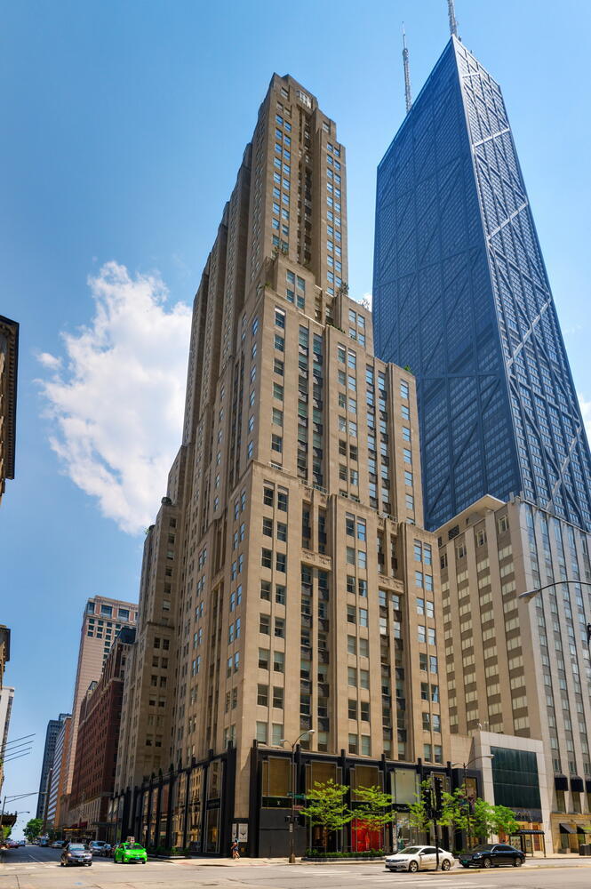 Exquisitely appointed and thoughtfully designed, this 4,700+  square foot full-floor residence on the 34th floor of the iconic Palmolive is not to be missed. Featuring three ensuite bedrooms plus a dramatic corner office/den, along with 3.1 baths, this home offers both scale and sophistication. With graciously proportioned rooms and refined detailing throughout, it lives like a single-family home in the sky ideal for displaying art while capturing sweeping lake and city views.  Your private elevator opens directly into an elegant foyer with herringbone floors, leading to a gallery corridor, the perfect setting for showcasing an art collection and setting the tone for the timeless design within. Bathed in natural light, the formal living and dining spaces are perfectly suited for both grand entertaining and intimate gatherings. At the northeast corner, a showstopping office/den wrapped in luxurious wood and anchored by a fireplace with a striking art deco surround provides corner windows and panoramic views of the lake and skyline an inspiring setting for work or retreat.  The eat-in kitchen is a chef's dream, appointed with Wolf, Sub-Zero, and Thermador appliances, granite countertops and backsplash, a butler's pantry, and custom cabinetry, all overlooking Lake Michigan.  The primary suite spans the west wing and offers a true private sanctuary. A sitting room at the entry serves as a versatile retreat, while the bedroom itself boasts sparkling northwest corner views. The spa-like ensuite bath includes a Whirlpool tub, separate shower, private commode, double sinks, separate vanity, and east-facing lake views. A custom dressing room completes the suite, with exposures down Michigan Avenue. Two additional bedrooms, both with ensuite baths and excellent closet space, round out the private quarters. A powder room, laundry room, and ample storage further enhance the home. The Palmolive Building offers world-class amenities: 24-hour door staff, onsite manager and engineer, gym, Whirlpool, steam room, and the Beacon Club party room. An onsite valet garage is available, with parking rights for two cars included in the price.