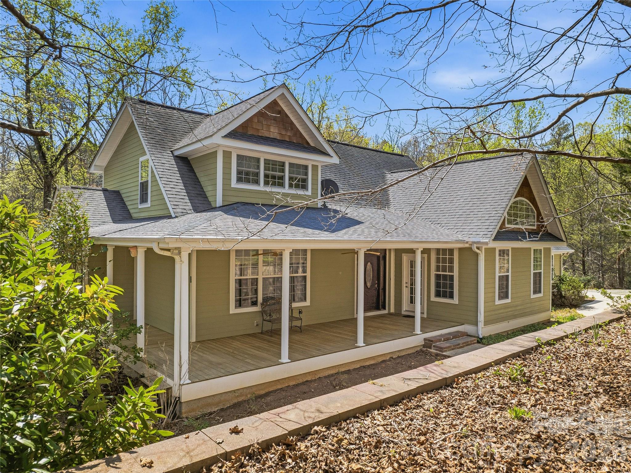 With room for everything you need and more, this spacious home offers a private, wooded retreat on almost three acres in the desirable Red Fox neighborhood—and more than 4,000 SF of thoughtfully designed living space. A covered front porch welcomes you into an inviting entryway that flows seamlessly into a light-filled living room and open kitchen. Hardwood floors run through the living room and main-level primary suite, while expansive windows fill the space with natural light and the serenity of its woodland surroundings. The kitchen is both functional and spacious, featuring tiled countertops, a built-in oven and microwave, and a gas cooktop. Also on the main level, a generous sunroom provides additional living space and direct access to a brand-new deck (2026), perfect for entertaining or relaxing in the peaceful setting. The main-level primary suite offers comfort and convenience, while the upper level includes an open family area with hardwood flooring, two additional bedrooms, and a full bathroom. The lower-level walkout basement adds incredible flexibility with a bedroom, full bathroom, half bathroom, wine cellar, tiled flooring, and a second gas fireplace—ideal for guests, recreation, or additional living space.With three levels, a two-car garage, and additional storage below, this home offers versatility for a variety of lifestyles, including the option for multi-generational living…and all in a tranquil refuge to call your own.