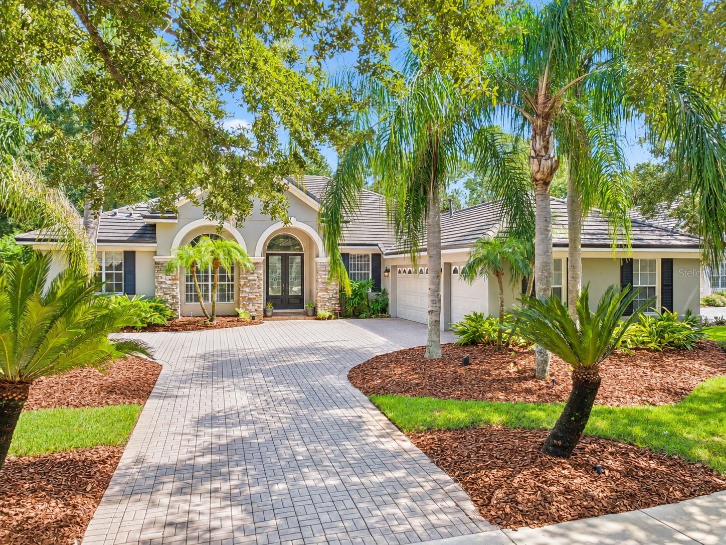 Welcome to 3387 Regal Crest Drive-an elegant golf front residence ideally positioned along the 7th fairway of the Legacy Club within the prestigious guard-gated community of Alaqua Lakes. Offering 3,038 square feet of beautifully designed living space, this home features 3 bedrooms, 3 full baths and a dedicated over-sized office that can easily be converted to a 4th bedroom.A refined interior showcases timeless architectural details including crown molding and coffered ceilings throughout. The formal living room is anchored by a fireplace and enhanced by a wet bar with a wine refrigerator creating a sophisticated setting for entertaining. A separate formal dining room provides an elegant space for hosting family and guests.At the heart of the home, the kitchen opens naturally to the spacious family room creating an inviting and functional layout for everyday living. Custom built-ins add both character and style to the family room while providing a beautiful focal point and additional display and storage space. Designed to embrace the Florida lifestyle, the living areas flow effortlessly to the expansive lanai, outdoor summer kitchen, screened sparkling pool and spa offering a private oasis for relaxing and entertaining.With its desirable golf-course setting, gracious formal spaces, custom architectural details, versatile floor plan and resort-style outdoor living, this residence offers an exceptional opportunity to enjoy the privacy, elegance and lifestyle of Alaqua Lakes. This home is covered by a whole home warranty to also cover the pool/spa and is transferable to the new owner. Alaqua Lakes is set within a premier golf course community where residents enjoy world-class amenities including clay tennis courts, a resort-style pool, playground and sports field, a 24-hour guard-gated entrance and enhanced community security. Located near A-rated schools, Central Florida’s best attractions, upscale shopping and dining, major highways and international airports.
