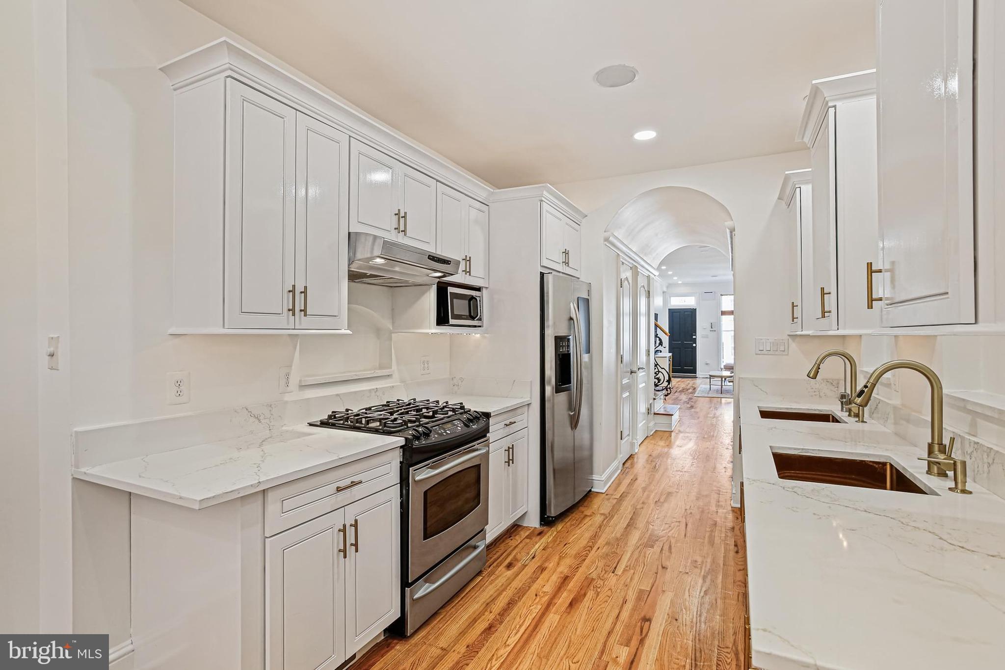 Experience sophisticated city living in this beautifully updated colonial just steps from Baltimore Inner Harbor. This recently renovated brick-front home blends timeless architecture with modern luxury across three spacious levels.Inside, you'll be greeted by rich hardwood floors, soaring ceilings, elegant crown molding, and recessed lighting throughtout. The open living room flows seamlessly into the gourmet kitchen, with high-end stainless steel appliances, dual sinks, granite countertops, and generous storage space.The dramatic dining area, featuring a striking two-story ceiling, sun-filled picture windows, and a cozy gas fireplace. From here, step out to the rear patio for indoor-outdoor entertaining.Upstairs leads to a loft area that overlooks the dining room below.  Enjoy your second-level  guest suite including and spa-inspired  bath with double vanities and walk-in shower.The third floor offers a private retreat. Enjoy your primary suite with a seperate dedicated office space,  a full ensuite bathroom with a recently refinished claw-foot tub, and access to a rooftop deck with breathtaking panoramic views of the city skyline.Located minutes from premium shops, gourmet dining, and top-tier entertainment—with easy access to I-695, I-83, and I-95—this stunning home delivers urban convenience and upscale comfort in one of the city’s most desirable locations.Call agent for a showing today!