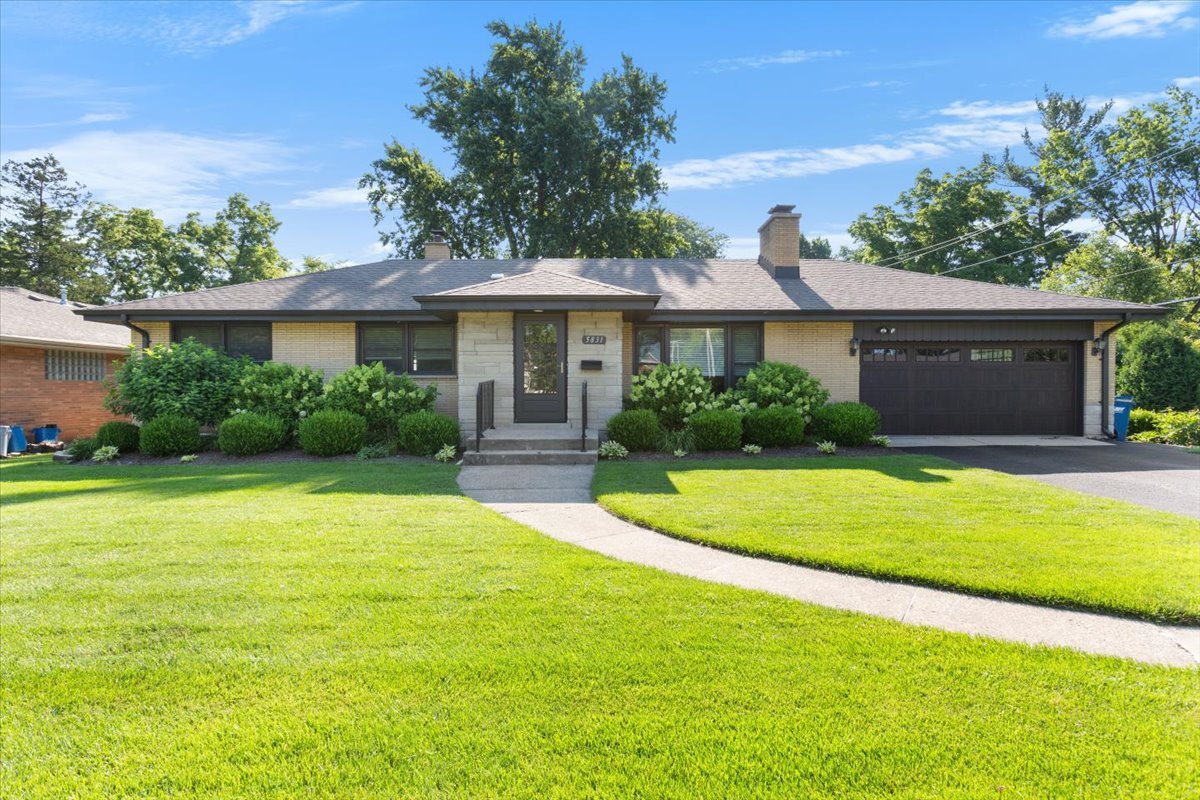 Meticulously maintained brick ranch situated on a generously sized lot. The home features a spacious living room with hardwood floors and a stone fireplace, along with a separate dining room also finished with hardwood flooring. The large eat-in kitchen offers ample space for everyday use. The full basement includes an additional fireplace and a bathroom, providing flexible space for a variety of needs. An attached oversized two-car garage offers convenient parking and storage. Located near parks, schools, and the YMCA, with easy access to downtown Downers Grove, the Metra train, and major expressways.