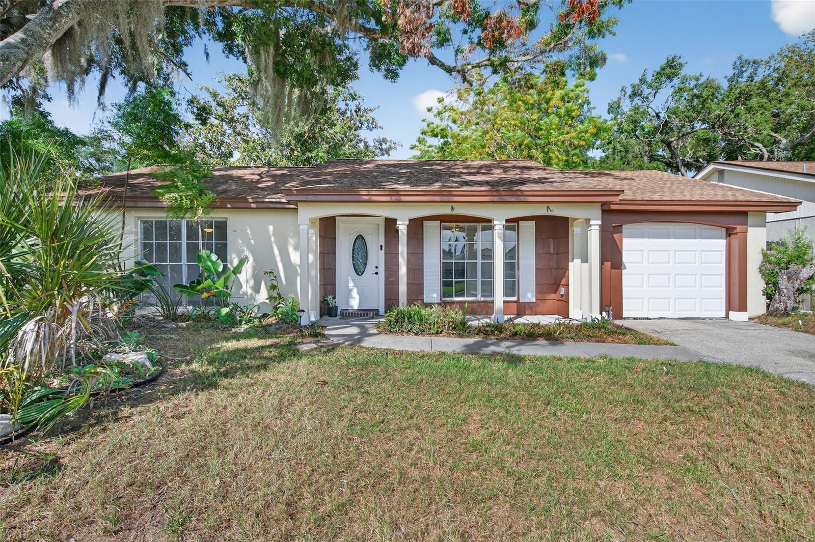 FHA and VA offers welcome!  Affordable 3-bedroom, 2 bath home located in the desirable Beacon Woods community.  LOW monthly HOA is less than $21 per month. This move-in-ready home features a spacious open floor plan with tile flooring throughout the home. The kitchen offers a functional layout, Stainless Steel appliances, and connects seamlessly to the main living spaces, perfect for everyday living and entertaining.  Located on a a Cul-De-Sac road, enjoy peace and privacy. AC installed in 2020 and the dimensional shingle roof in 2011. All bedrooms are generously sized with ample closet space. The home includes a one-car garage and sits on a nicely sized lot with mature trees.  Residents of Beacon Woods enjoy access to a clubhouse, heated community pool, tennis and basketball courts, racquetball, shuffleboard, and picnic areas. Conveniently located near shopping, dining, medical facilities, and just a short drive to the Gulf beaches.  Schedule your private showing today and experience all that this inviting Hudson home and community have to offer.  All information believed to be accurate and should be verified by the buyer(s).  Please note:  The garage bathroom only has a shower and toilet, no sink.