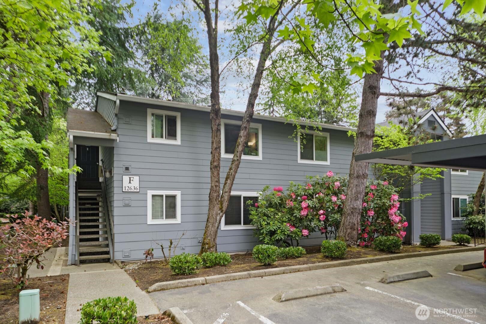 Welcome home to this peaceful, intentionally updated ground-floor condo in the heart of Juanita. Step inside, and the home unfolds with natural continuity, drawing you from the kitchen through the dining and living spaces and out to a lush private patio overlooking a calming water feature. Great flow is what makes this home feel so special: open, warm, grounded, and easy to live in. Thoughtfully updated with luxury vinyl plank flooring, fresh interior paint, warm natural light, and modern, calming tones, the home has been improved with purpose throughout. The fireplace anchors the living room with cozy Pacific Northwest charm, while the oversized patio extends the living space outdoors. Both bedrooms are generously sized, with ample closet space and soft natural light that creates a quiet, retreat-like feel. Bathrooms feature resurfaced tubs/showers, new toilets, and updated finishes. Major updates include a new water heater, new dishwasher, updated electrical details, and extensive cosmetic improvements throughout. Assigned covered parking, ample guest parking, and a tasteful clubhouse with pool, spa, fitness center, and game room round out this Kirkland Springs retreat. A move-in-ready opportunity close to Juanita Beach, restaurants, coffee shops, Downtown Kirkland, and I-405 access.
