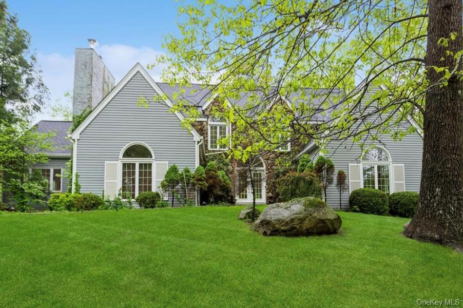 Elegantly updated Modern Colonial with majestic curb appeal on a quiet country cul-de-sac. Ten minutes to Wilton/New Canaan (Connecticut) train stations. Picture perfect corner lot in gorgeous Northern Westchester, A grand foyer with double height ceilings ushers you into generously sized rooms with three cozy wood burning fireplaces. Eight French doors from three welcoming rooms open out onto a enclosed three season wraparound rear deck nestled within serene woodlands. Enjoy family and entertain amid tree top views and the sounds of a flowing brook. The main floor includes a private guest suite/ office space with its own fireplace, full bath and wardrobe. The inviting eat-in kitchen with new build-in bar and pantry opens onto a large airy family room with high ceilings and a rustic fireplace. Double French doors open onto an eight-person jacuzzi on the main upper deck which leads to an over-sized adjacent covered wraparound deck. Fantastic for entertaining indoors and out. Second floor with a catwalk hallway leading to the magnificent main bedroom suite with soaring ceilings, wall-to-wall wardrobes and a stunning marble bathroom with spa-jet bathtub and waterfall shower. Large walk-in closet and additional storage in the attic above. Two additional high-ceilinged spacious bedrooms and an adjoining newly styled Jack-and -Jill bathroom. An additional 700 sf of living space in the newly finished lower level. Game room, exercise room, man cave or guest suit with double French doors which open to a spacious separate room with full bath. Bucolic front yard with mature flowering trees, new sprinkler and drip systems and two car garage. Additional storage space in basement and shed.