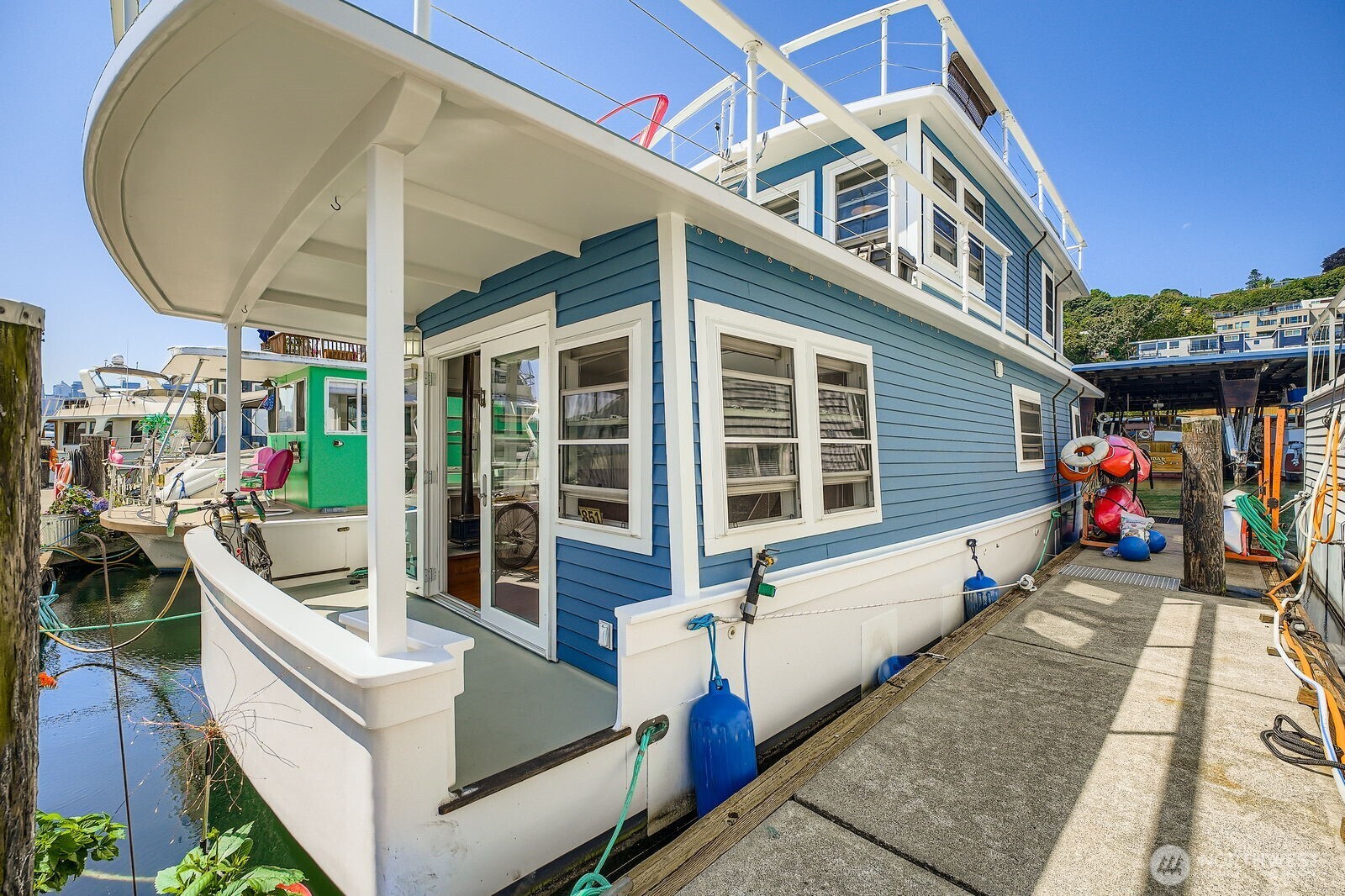 Welcome aboard to this end-of-dock Seattle Houseboat with breathtaking water views.  Relax on the spacious rooftop deck or two covered main-level decks.  Enjoy vaulted ceilings, walls of windows, full kitchen with breakfast bar, built-in queen bed, full bath, and washer/dryer combo.  The upper bonus room with built-in bar is perfect for guests, entertaining, or home office.  You will love watching the fireworks, Duck Dodge, water planes, & incredible sunrises over Lake Union.  Slip lease is $1,598/mo & includes moorage, insurance, DNR, facility fees, liveaboard status, & Property Data Protection.  Paddleboard, kayak, or relax while living the lake lifestyle.  Financing available.  Minutes to Amazon, Google, & Adobe.  Pets & rentals OK.