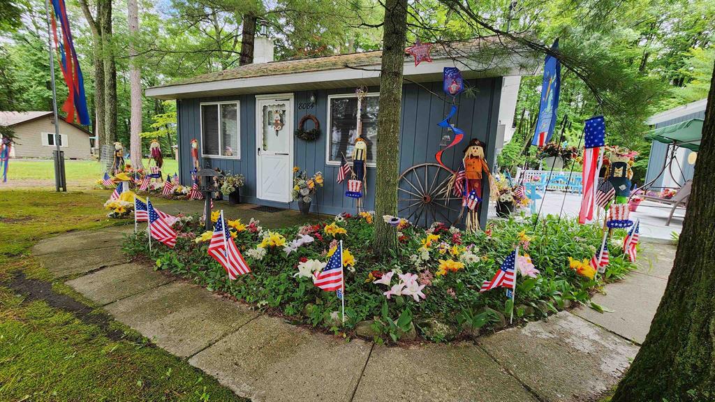 Enjoy peaceful lake living in this beautifully maintained 2-bedroom, 2-bathroom cottage. Located just across the road from Long Lake, this home offers convenient waterfront access via the included half-lot across the street. With three and a half lots on the back side, this property offers a large yard, generous deck, and plenty of room to relax or entertain. 24 kilowatt Generac. With lake views, direct access, and a cozy interior, this property is perfect as a year-round residence or a seasonal retreat. Dont miss your chance to own a slice of Michigan paradise.