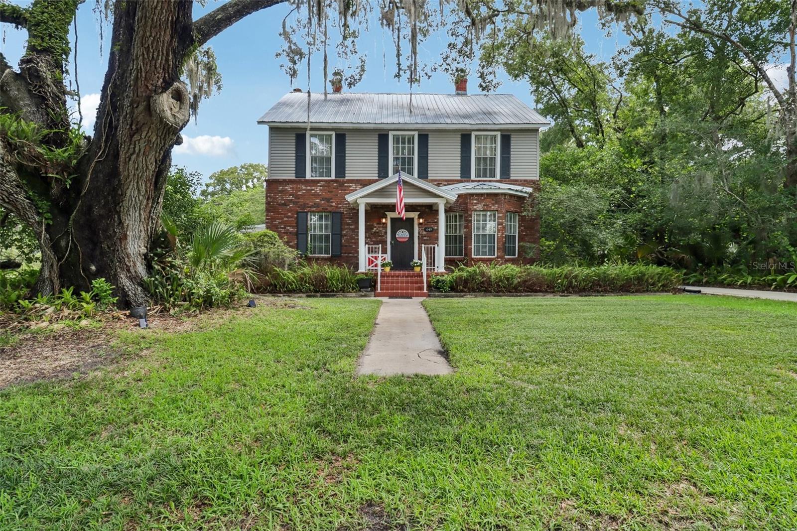 Step into timeless elegance with this breathtaking 1901 Colonial-style estate, perfectly nestled beneath majestic oak trees on a private 0.75 acre lot in the heart of historic downtown Sanford. Rich in character and thoughtfully updated, this one-of-kind property seamlessly blends historic charm with modern comfort. Offering 5 spacious bedrooms and 2 bathrooms, this remarkable home features expansive living and gathering spaces designed for both everyday living and unforgettable entertaining. The oversized great room provides the perfect setting for family gatherings, while the outside has multiple outdoor entertaining areas, creating a seamless indoor-outdoor lifestyle. The backyard is a true private retreat, complete with a sparkling pool, mature landscaping, and plenty of room to relax or host guests. A versatile barn adds endless possibilities for storage, hobbies, a workshop or future creative use. From its stately Colonial architecture and picturesque setting to its exceptional amenities and unbeatable downtown Sanford location, this extraordinary property is a rare opportunity to own a piece of history with all the space and features today's buyers desire. Just moments from vibrant dining, shopping, parks, the waterfront and community events, this is a home where timeless beauty meets modern living.