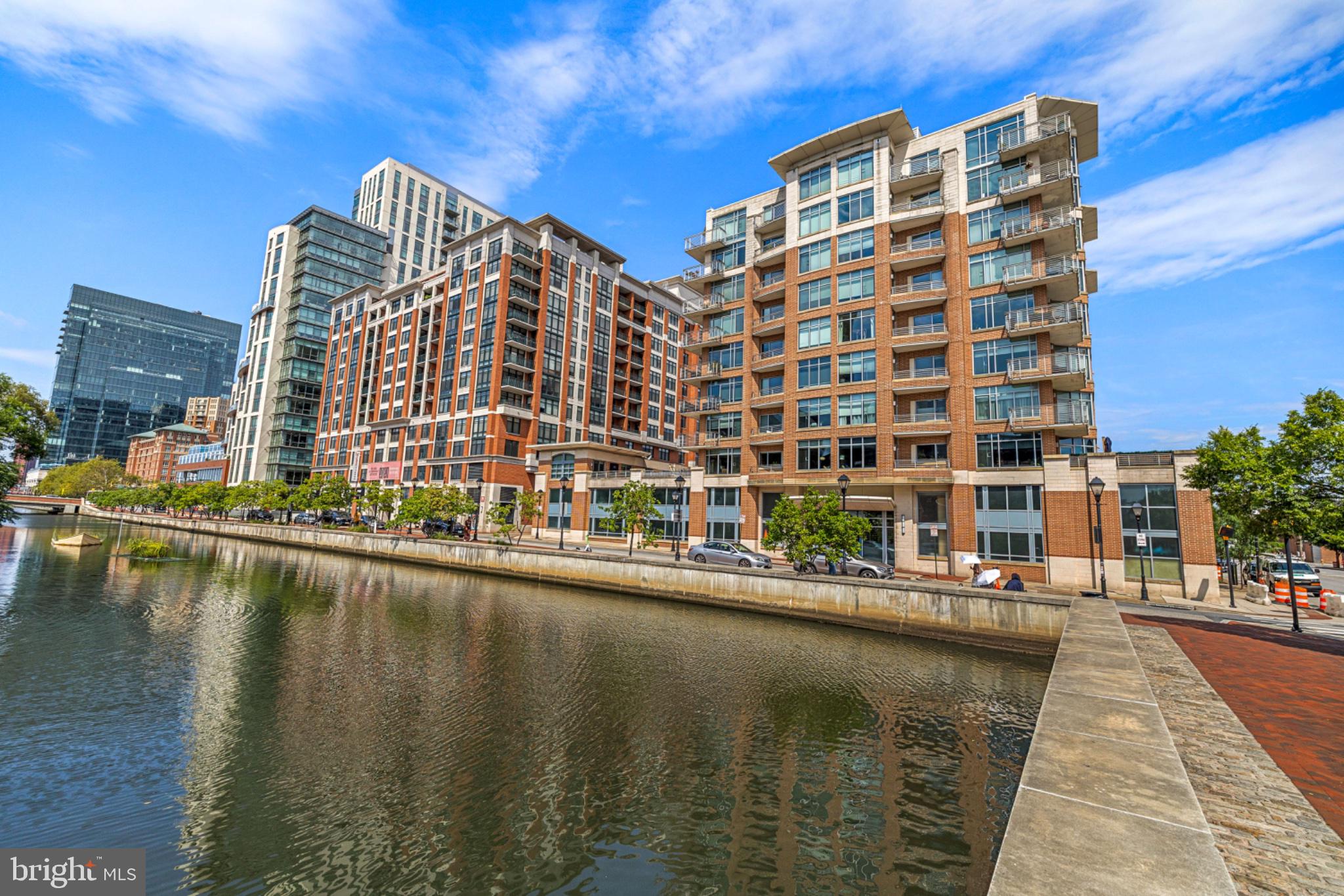 Turn-key Harbor East condo offering spacious living, beautiful views, and an abundance of natural light. This thoughtfully designed 2-bedroom, 2.5-bath residence features an open-concept layout connecting the living room, dining area, and kitchen—perfect for everyday living and entertaining. The living room is anchored by a striking focal-point fireplace and offers access to one of two private balconies.The well-appointed kitchen features generous counter space, custom cabinetry, and stainless-steel appliances. The spacious primary suite provides a relaxing retreat with a grand en-suite bath complete with a soaking tub, walk-in shower, and dual vanity, plus a large walk-in closet. The second bedroom offers its own attached full bath and walk-in closet, providing privacy and flexibility for guests, family, or a home office. The condo is complete with a laundry room and half bathroom. Enjoy outdoor space from the two balconies located off the bedrooms, with convenient access from the living room. This secure condominium includes two parking spaces and additional storage, adding to the convenience of city living.Ideally located in Baltimore’s sought-after Harbor East, just two blocks from Whole Foods and surrounded by an impressive selection of restaurants, shops, and entertainment. Fells Point is also just a short stroll away. A wonderful opportunity to enjoy spacious, turn-key living in one of Baltimore’s most vibrant waterfront neighborhoods.