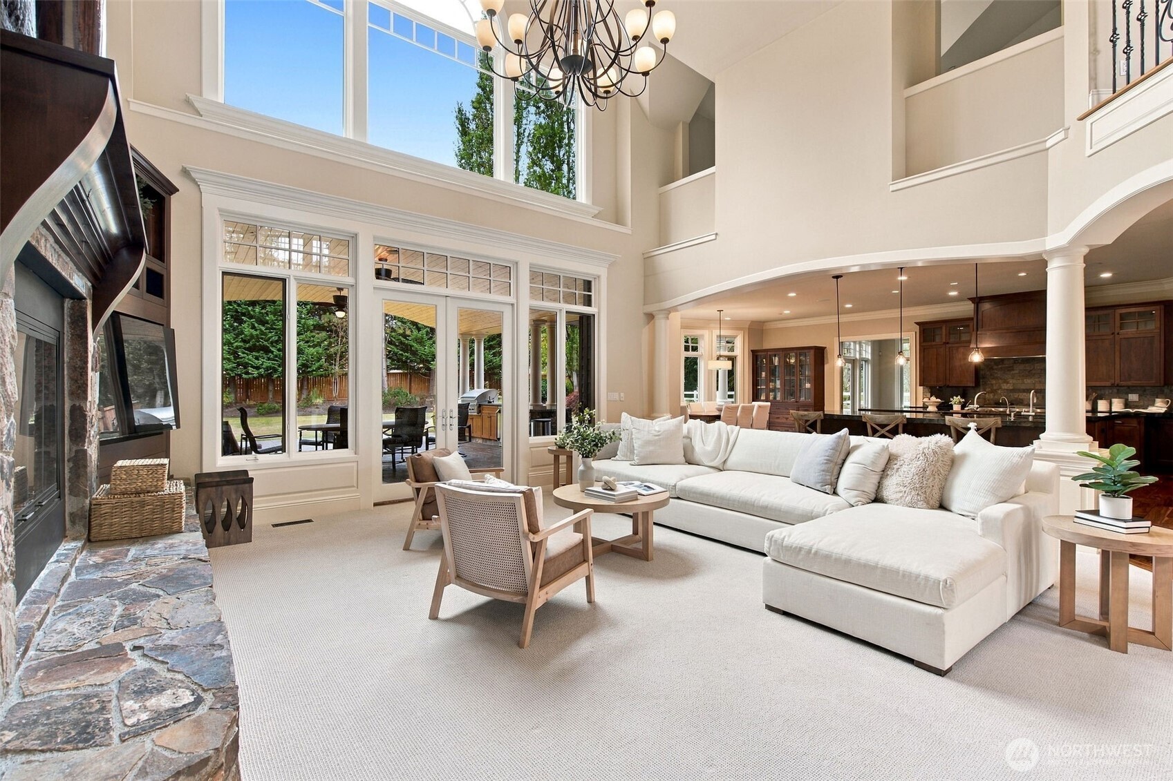 Walls of windows and French doors fill this inviting living space with natural light.