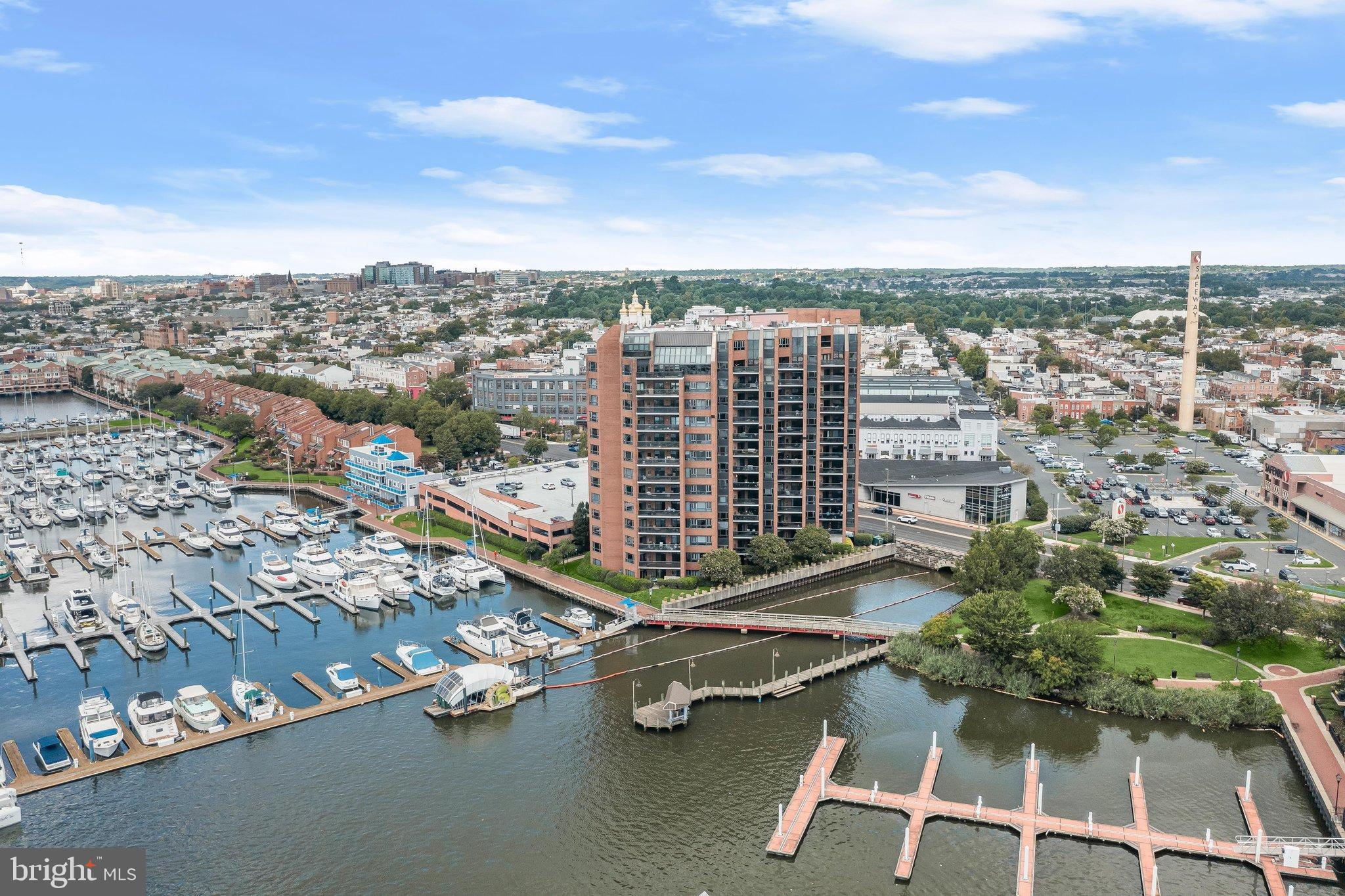 Luxurious waterfront living with exceptional views of the harbor, Fort McHenry and the city skyline await you at this inviting two bedroom, two full bathroom condo located on the eleventh floor in the prestigious Anchorage Tower of Canton. Enjoy the conveniences of a secure lobby with 24-hour front desk attendants, two assigned parking spaces in the gated garage, an indoor storage unit, along with exercise and community rooms. The unit itself is bathed in natural light with hardwood floors throughout the open concept dining and living areas. You will love spending your mornings enjoying a cup of coffee or evenings unwinding out on the covered private balcony with spectacular views. Prepare your favorite meals in the kitchen that is equipped with stainless steel appliances, granite countertops, a tile backsplash, a breakfast bar, and 42-inch cabinets with lighting and a pull-out pantry. The primary bedroom suite is a true retreat with four closets and a luxurious en-suite bathroom with a soaking tub and frameless glass-enclosed walk-in shower. Completing the unit is a second bedroom, second full bathroom, laundry closet with full size washer and dryer, and two additional hall closets for added storage space. This impressive unit offers the best of vibrant downtown living, with the Waterfront Promenade, water taxi, Swim Club, Boston Street Pier, and Canton Waterfront Park just steps from your door. With Safeway across the street and nearby Canton Crossing, Merritt Clubs Canton, O’Donnell Square, along with a wide variety of acclaimed restaurants, shops, and entertainment nearby, everything you need is within easy reach. Spend the day exploring the charming streets of Fells Point, enjoying the green spaces of Patterson Park, or taking advantage of all that Canton has to offer. Recent updates include a brand new refrigerator (2026), microwave (2025), water heater (2019). Parking spaces 208, 324.