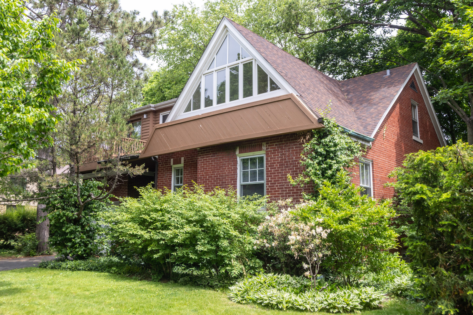 Gorgeous views of Westmoreland Country Club's golf course can be yours every day from this two-story expanded bungalow in NW Evanston.  Second floor includes a primary bedroom suite with vaulted ceiling, skylight, full bath and large walk-in closet.  A huge open bright family room with skylight, high ceilings, numerous windows and a balcony complete the upper level of the home.    Lovely details including a woodburning fireplace, arched doorways, hardwood floors, over-sized closets, built-in cabinets and cove moldings complement the main floor design. The first floor includes a full bath and two large bedrooms, one of which has been used for many years as a formal dining room (by adding an arched doorway from the original dining area.) This room could easily be returned to its former use as a bedroom.  The one car garage can be accessed via the kitchen, as can the full unfinished basement.  Come be inspired to create the perfect updates for this unique property.