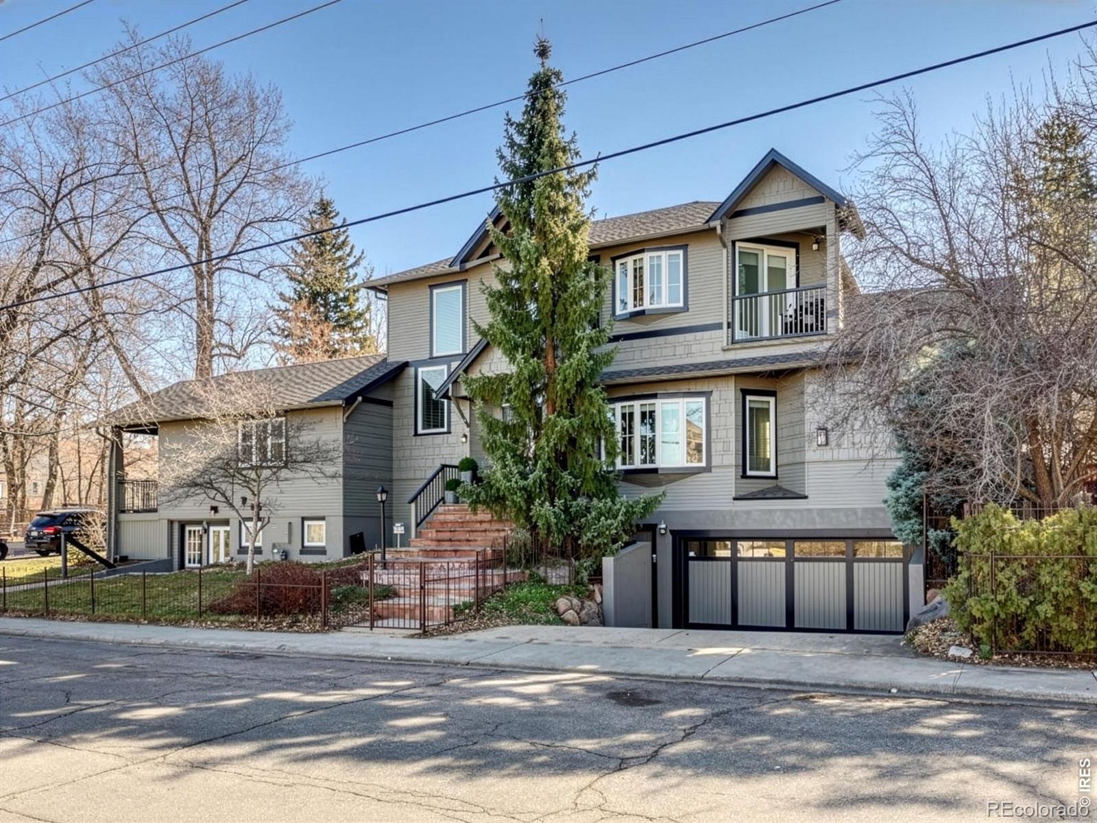 Perfectly positioned in West Rose Hill to capture sweeping Foothill and Flatiron views, this beautifully renovated residence blends historic Boulder charm with bright, contemporary living. The thoughtfully updated main level features a spacious primary suite with a private covered porch, site-finished hardwood floors, radiant heat, quartz countertops, maple soft-close cabinetry, a Wolf gas range, and two Fisher & Paykel dishwashers. A heated driveway adds rare year-round convenience, while the inviting great room-with vaulted ceilings and a gas fireplace-creates a warm, expansive gathering space. Designed for flexibility, the floor plan includes a main-level primary suite, two upstairs bedrooms, and a private lower-level suite with two separate entrances and a rec room or additional family room-ideal for a live-in nanny, guests, or multigenerational living. Bathrooms on all three levels enhance comfort and convenience. Set on a fully enclosed private corner lot, the outdoor spaces include irrigation, garden areas, and custom wrought iron fencing. Recent improvements include a beautifully renovated kitchen, updated powder room and guest baths, new A/C, a new back deck, upgraded lighting throughout, and more. Ideally located near Chautauqua Park, Flatirons Elementary School, Alpine Modern Cafe, and Pearl Street Mall, this home offers an exceptional opportunity to enjoy the very best of Boulder living.