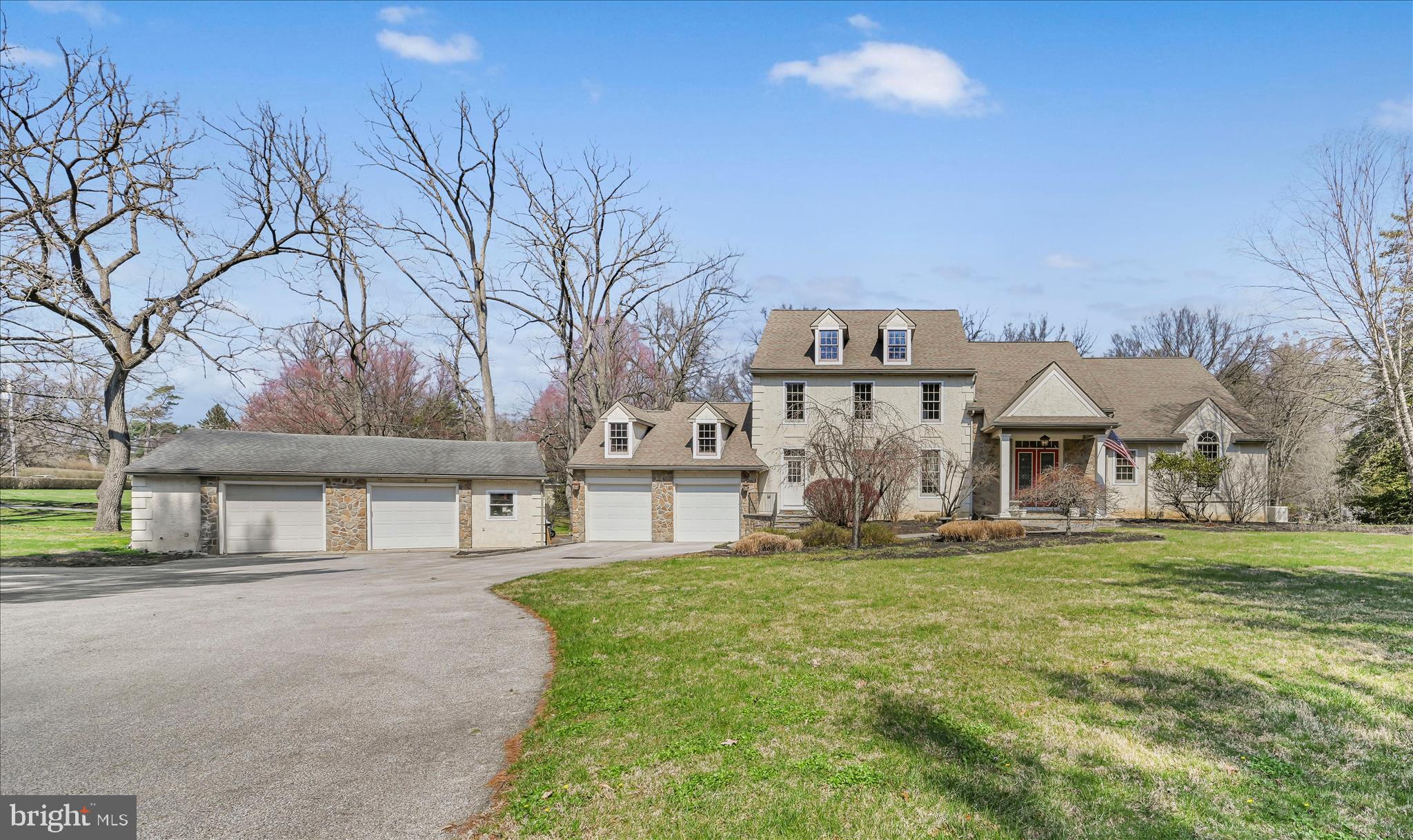 Set on a picturesque 1.8-acre lot with a tranquil creek and frequent visits from local wildlife, this custom-built residence offers a rare blend of craftsmanship, space, and natural beauty. Thoughtfully designed and meticulously maintained, the home welcomes you with a dramatic open entryway and rich Brazilian cherry hardwood floors that flow throughout the main level. At the heart of the home, the great room impresses with soaring vaulted ceilings and a striking wall of windows that flood the space with natural light while framing serene outdoor views. A double-sided gas fireplace creates a warm connection between the great room and the informal dining area, adding both charm and functionality. The kitchen is designed for both everyday living and entertaining, featuring an oversized island, granite countertops, two sets of sinks, one overlooking the backyard and then an additional deep sink, gas cooktop, double wall ovens, and a generously sized pantry, complemented by a separate wet bar for added convenience. A formal dining room with high end crown molding offers an elegant space for gatherings. The main-level primary suite is a private retreat, complete with vaulted ceilings, direct access to the deck, and an expansive custom walk-in closet. The ensuite bath showcases block tile details, a marble vanity, and a spacious tiled steam shower, creating a spa-like atmosphere. Upstairs, a custom-crafted handrail leads to a loft area and catwalk that overlook the main living space, enhancing the home’s open and architectural appeal. Four additional bedrooms provide flexibility, with one currently used as a sitting area or office. Comfort is ensured year-round with a three-zone gas forced air heating and central air conditioning system. The unfinished basement is exceptionally clean and offers future potential, with a nearly completed full bathroom already in place. Outdoor living is equally inviting, with a large deck ideal for relaxing or entertaining while enjoying the peaceful surroundings. Additional features include gutter guards and a whole-house Generac generator for added peace of mind. A standout feature of the property is the detached oversized two-car garage, previously used as a workshop, complete with its own heating, central air, and half bath—perfect for hobbyists, entrepreneurs, or additional workspace needs. To complete the offering, the seller is including a one-year home warranty, and new smoke and carbon monoxide detectors have been recently installed. This property combines thoughtful design, quality finishes, and a scenic setting to create a truly distinctive place to call home.