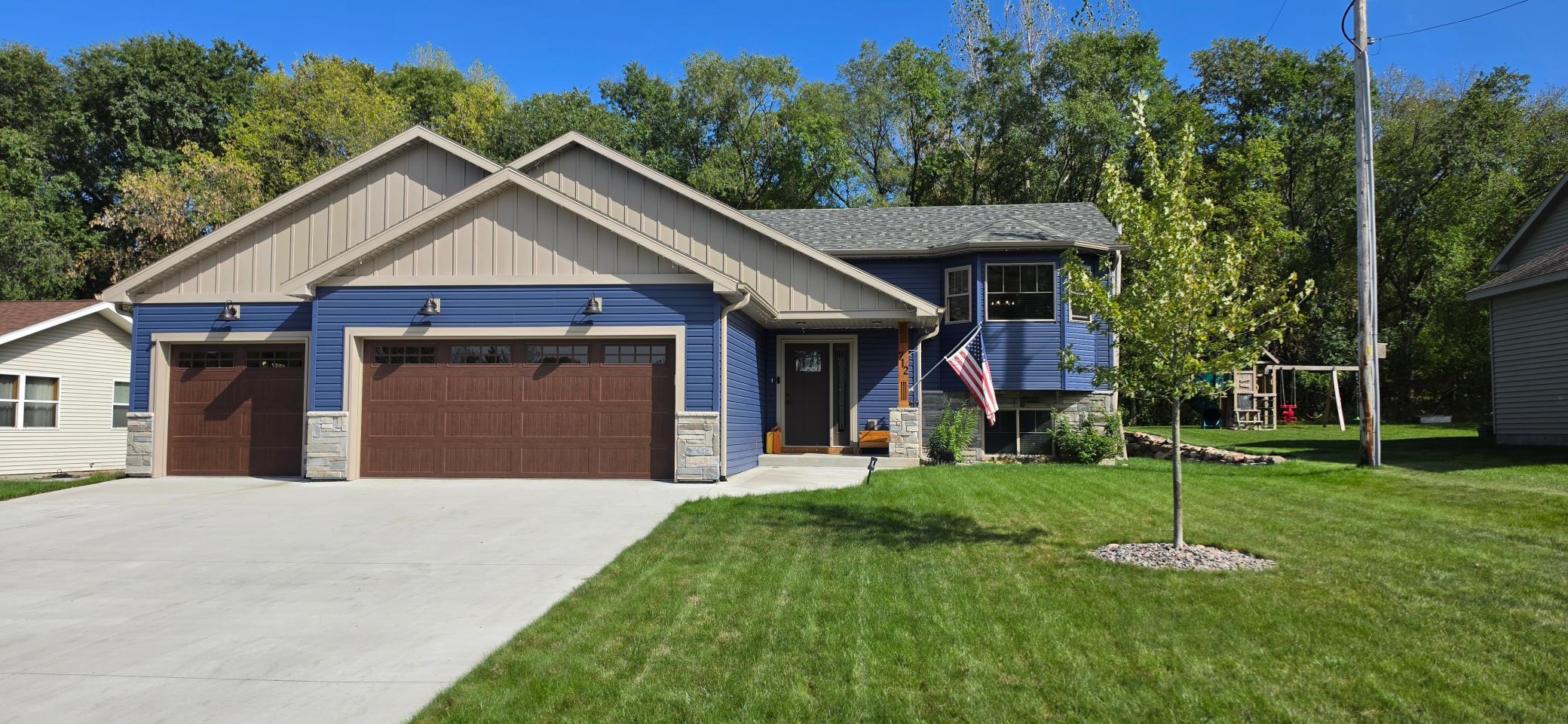 Not your cookie cutter home!! This almost new custom build was created with comfort and amenities in mind, and will have you feeling completely at home. Drive up the perfect concrete driveway into your oversized, insulated and heated garage with extra deep 3rd stall. Step into your large entryway and notice the upgraded finishes right away including doors, flooring, and trim! Upstairs, your kitchen will be the envy of guests with plenty of storage, beautiful granite tops, soft close cupboards and drawers, undercounter lighting, and the coolest stand mixer storage! Dining area is spacious and looks out to your large deck and peaceful backyard. Living room is full of natural light, and with the vaulted ceilings and open floor plan, everything flows very nicely. Owner's suite has a large bedroom with layout options, huge bathroom/WIC with double sinks, tiled walk in shower, and tons of storage with soft close doors and drawers! So nice, you may not need the rest of the house...Lower level has an enormous family room with 2 more bedrooms. Laundry room is fully finished, bright, and clean. LL full bath completes this area. Other things to appreciate inside this amazing home include double hung windows on the upper level for easy cleaning, custom fitted wood blinds, quality tile and granite throughout, bullnose corners which add a softness to the home, and even a hot/cold spigot in the garage to give the cars a quick bath inside if needed! Outside the home you see the attractive look of the board and batten, along with well chosen colors. In-ground sprinklers, manicured yard, excellent landscaping, storage shed, lean-to for firewood, smokeless block fire pit, large deck with maintenance free railings, and permanent Govee lighting around the house! At barely 3 years old, you have a basically new build home, but all the extra finishing work is already done, so you can purely enjoy the home. You have got to see this one!