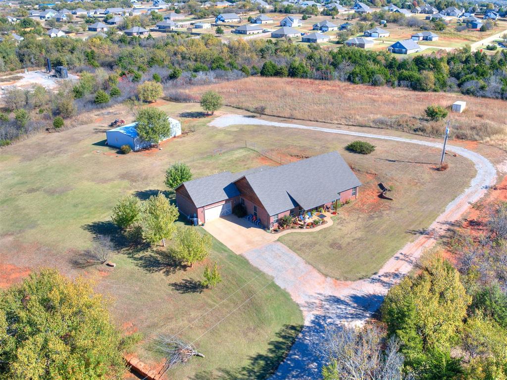 Welcome home to this beautiful 4-bedroom, 3-bath modern traditional on 2 peaceful acres in the Deer Creek School District. With 2,340 sq. ft. of comfortable living space, this home features an open floor plan, spacious kitchen, and cozy living area perfect for family gatherings. The dedicated study is ideal for working from home or homework time. Outside, you’ll find a 30x50 fully insulated metal shop with plumbing and electric—perfect for hobbies, storage, or a small business setup. Enjoy the freedom of no HOA and your own private well, all surrounded by plenty of room to play, garden, or simply relax and take in the quiet country setting. The perfect blend of modern style and classic charm, just minutes from schools, shopping, and dining!
