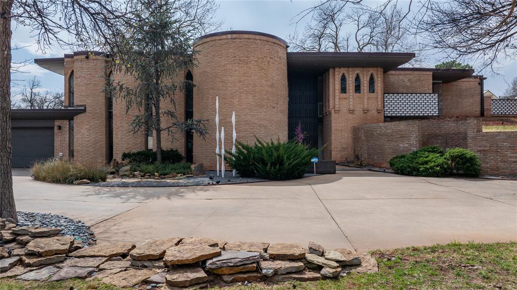 Tucked into the highly desired Quail Creek neighborhood and just steps from the renowned golf course, this striking mid-century modern home is a rare architectural gem that perfectly blends timeless design with exceptional outdoor living. Defined by tall ceilings, expansive glass windows, & clean mid-century lines, the home feels like stepping into a beautifully preserved time capsule—ready for its next chapter. Designed for entertaining, the main level features an open living, kitchen, & dining concept that seamlessly overlooks the backyard oasis. Walls of glass bring the outdoors in, creating an effortless connection to the pool, pickleball court, & expansive entertaining spaces. The backyard is truly one of a kind, featuring turf for low-maintenance living, a sparkling pool with spa, & an incredible swim-up bar—an entertainer’s dream. A secondary storage area adds convenience while maintaining the clean aesthetic of the space. Upstairs you’ll find three spacious bedrooms, along with a dedicated office and a second living area, offering flexibility for work, relaxation, or guests. Additional features include an attached garage and a unique pull-through driveway with access from both Partridge & 122nd, providing exceptional convenience & functionality. With its iconic architecture, large-scale windows, & incredible indoor-outdoor flow, this home offers an opportunity that is nearly impossible to replicate today—you simply could not construct a property like this for under $900,000. A truly special Quail Creek residence ready to welcome its next owner.