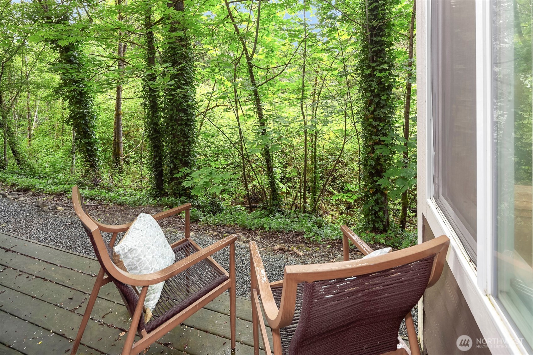 This home as it all- private serene outlook, comfort, value, and location. Positioned in a peaceful ground floor location overlooking a lush greenbelt and the Rainier Trail. Featuring new luxury vinyl plank flooring, an open layout, cozy wood-burning fireplace, in-home laundry, and private parking space. Light-filled living space with expansive windows that open to an outdoor deck, great for relaxing or entertaining. Enjoy community amenities such as fitness center, clubhouse, hot tub and scenic trails. No rental cap making a perfect home or investment opportunity with a prime Issaquah location just minutes to I-90, shopping, dining, and more!