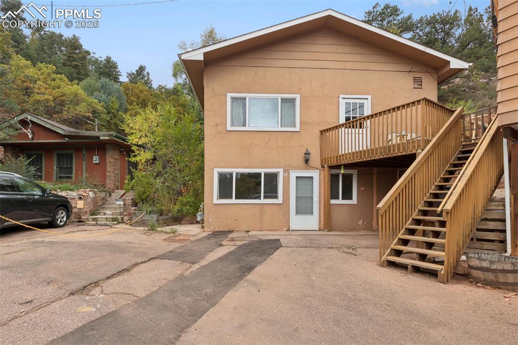 Discover the charm of Manitou Springs with this raised ranch tucked away on a quiet street, just a short walk to downtown shops, dining, and galleries, while still offering easy access to the highway for convenient commuting. This home features 3 bedrooms and 1.5 bathrooms, with a versatile layout that includes a basement offering additional flex space - perfect for a home office, workout room, or creative studio. Open the windows and you'll hear the soothing sounds of the nearby brook, or pop out the back door to experience it from the bridge. The deck and roof were both replaced less than 10 years ago, adding peace of mind and value. Whether you’re relaxing outdoors, entertaining, or simply enjoying the tranquil setting, this home balances convenience with the quiet retreat-like feel Manitou Springs is known for. *Note: the deck belongs with this property. The house next door and this one were once a single property, but they've since been split up. There is an access-only easement granted to the house to the right for the use of the stairs and deck, but it can be dissolved at any time with 30 days notice.