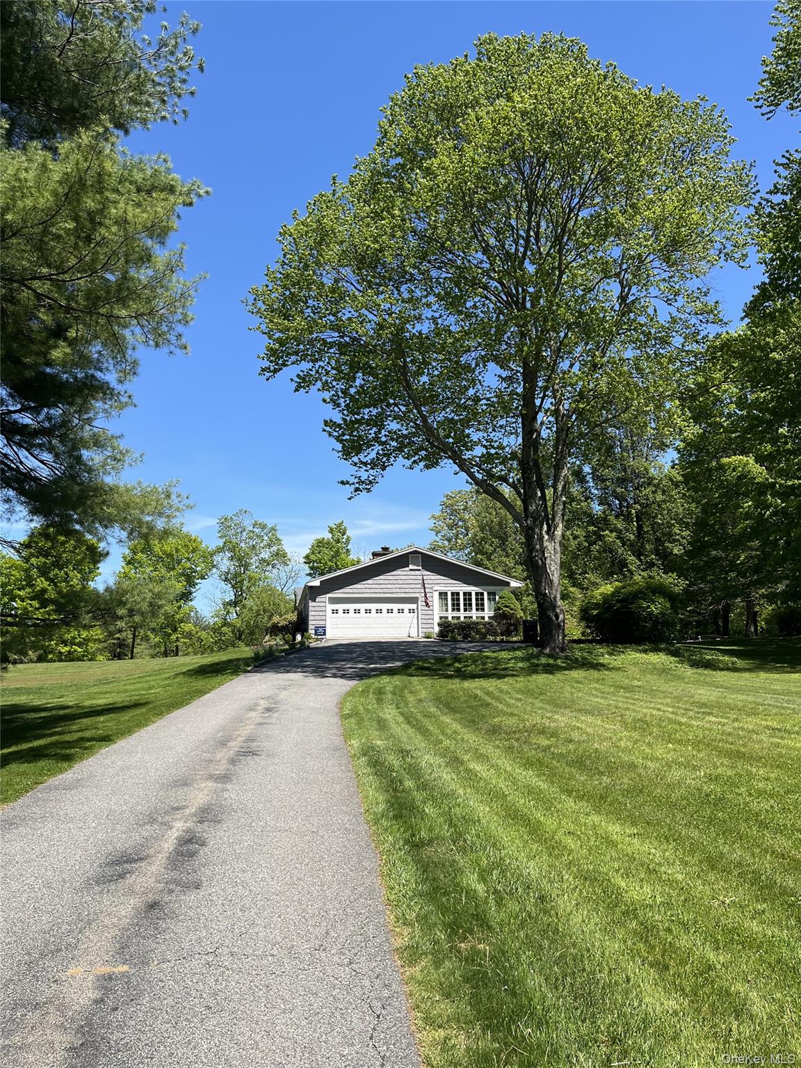 Welcome to 245 Salem Rd. in pastoral Pound Ridge, NY. This updated ranch sits atop a gently rolling hill amid a park-like setting with beautiful views from every window. The property has been recently updated with a new energy efficient heat pump system that provides year round cooling and heating. A partially finished basement includes walk-out access and a spacious home office. The warm interior features crown molding, generous skylights, and hardwood floors throughout. The newly remodeled,light-filled family room includes patio access through french doors that look onto the private backyard. The living room has a large bay window opening onto the lush green of the front acreage.The home is perfect for both indoor and outdoor entertaining.