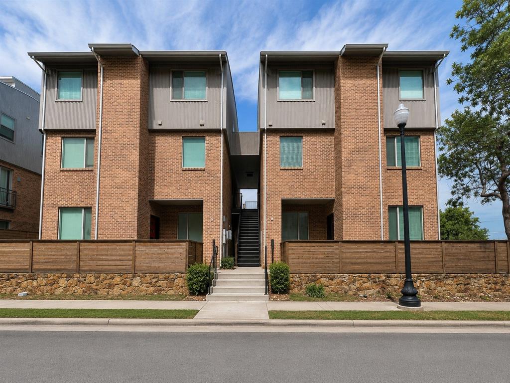 Welcome to 1300 May Street #200, a well-maintained two-story condo ideally located in the heart of Fort Worth's sought-after Hospital District. This spacious 2-bedroom, 2.5-bath home features an open-concept floor plan with abundant natural light and beautiful views from the private balcony off the living area and kitchen. The inviting living room is anchored by a cozy gas log fireplace, creating the perfect space to relax or entertain. Upstairs, both generously sized bedrooms offer private ensuite bathrooms and walk-in closets, providing comfort and privacy. The upstairs laundry area adds everyday convenience. One covered, assigned parking space is included. Enjoy an unbeatable location just minutes from the Medical District, downtown Fort Worth, Magnolia Avenue, shopping, dining, and major highways. A perfect combination of comfort, convenience, and low-maintenance living! Only 1 pet allowed with owner approval.