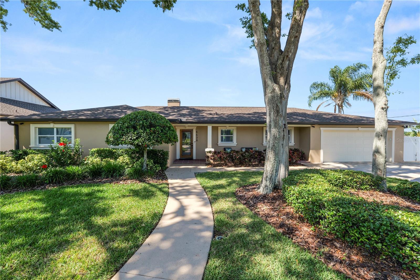 Lakefront living at its finest! This phenomenal home has 3 bedrooms, 2 bathrooms, and 2 additional bonus rooms currently used as the office and a window-lined “Florida” room. Sitting on over half an acre, with unrestricted views of the beautiful Lake Gibson in North Lakeland, it comes fully equipped with a private dock with covered boat slip and electric boat lift. This updated home has been meticulously maintained with a new roof installed in September of 2024, updated double pane windows, and new plumbing and electrical systems redone. This open concept home offers gorgeous views from nearly every living space blending the perfect combination of flow and functionality. The large living space includes a wood-burning fireplace and custom built-in shelving.The spacious kitchen boasts stainless steel appliances, gorgeous wood cabinetry and room for an eat-in kitchen in addition to the dining room space. It also has a separate dry bar area perfect for entertaining.The Florida room is complete with 3 sets of double French doors, and 33 feet of window-lined lakefront views. The French doors give you the flexibility to extend the main living space, or close off the room to be a dedicated bonus room. This room overlooks a large covered back porch. The private office space also has lake views and French doors leading to the back porch. The back porch overlooks a large manicured backyard with mature landscaping that’s equipped with an irrigation system that pumps water from the lake.The primary bedroom boasts gorgeous lake views through the French doors leading to a private patio area, and an en-suite bathroom with separate soaker tub, and walk-in shower, as well as 2 spacious closets.This home is located in North Lakeland with access to shops and dining, and convenient proximity to I-4.This home is positioned so perfectly, you won’t know where to sit to watch the sun set over the lake each day. Schedule your private showing today.