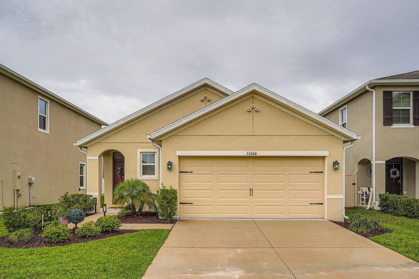 This well-maintained 3-bedroom, 2-bathroom single-family home offers comfortable living in a sought-after community. The open floor plan features a spacious living room, a functional kitchen with ample cabinet space, and a cozy dining area perfect for gatherings. The primary suite includes a walk-in closet and private bath with dual sinks. Two additional bedrooms share a full guest bathroom.  Enjoy added convenience with an attached 2-car garage, a laundry room, and a fully fenced backyard ideal for pets or outdoor relaxation. Located near top-rated schools, shopping centers, restaurants, and major commuter routes.  Low HOA, no CDD. Don’t miss this move-in-ready opportunity in the heart of Wesley Chapel!