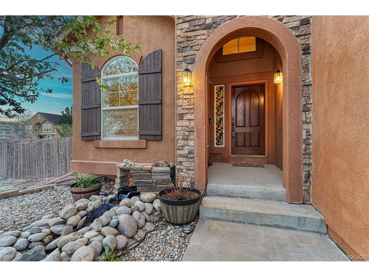 Comfort and Radiant Style | Beautifully Maintained two-story Home | NEW Basement Carpet | Nestled in the desirable Cordera Community.  Just steps from Chinook Trail Elementary & Middle School, this 5BR/3.5BA, 3,700+ SQFT residence evokes subtle Southwestern vibes with a gorgeous stucco exterior, tranquil fish pond, and covered entryway. The home is situated on a cul-de-sac lot with an entertainer's fully fenced-in backyard, covered backyard patio ideal for grilling, gardening and basking in unobstructed views of Pikes Peak. Brimming with natural light, the interior captivates with vaulted ceilings, hardwood entry floors, open layout, Pikes Peak views, attractive window coverings/blinds, whole house intercom system, home office, and an oversized living room. Enjoy the party possibilities of the adjoining formal dining room. Chefs and foodies are sure to delight in the gourmet kitchen featuring stainless-steel appliances (JennAir and Whirlpool), granite countertops, gas cooktop, built-in microwave, dishwasher, double wall ovens, French door refrigerator, 42" wood cabinetry, center island, walk-in pantry, recessed lighting, and an adjoining family room with gas fireplace. Oversized for maximum comfort, the primary bedrooms dazzles with a 3-sided fireplace, sitting room, walk-in closet, and an en suite boasting a jetted tub, dual sinks and radiant heat flooring. Two extra bedrooms and a full bathroom complete the upper-level, while the finished basement mesmerizes with two bedrooms, built-in wet bar, rec room w/fireplace, and a full bathroom. Additional considerations: attached 3+ car garage with bike storage, overhead storage, and freezer, LG washer/dryer & utility sink, Ring doorbell, security system w/cameras, Cordera Community Center & pool, close to shopping, hospitals, restaurants, and entertainment, near I-25 for easy commutes to Denver & Downtown Colorado Springs, and more! Become the newest Cordera home owners, and start living the good life!