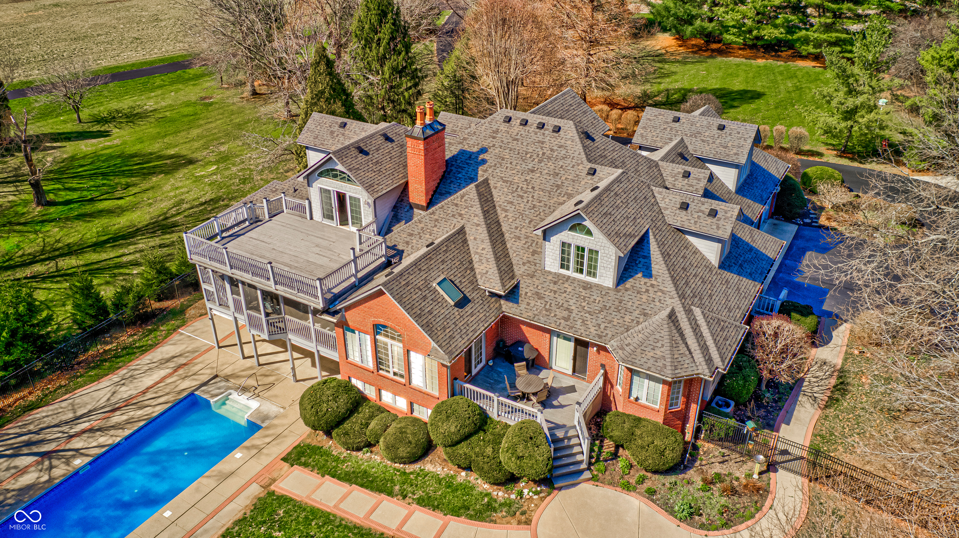 Thoughtfully placed on over four acres, with mature native growth alongside strategically cultivated trees and flowering landscaping, surrounded by similar estates, this property provides a retreat for all ages. Multiple decks and patios, both open and enclosed, a beckoning 30,000gal lap pool with unfinished pool house, a multi-level tree house, and fenced area offer private outdoor recreational enjoyment year-round. The grand foyer presents guests immediately with an unrestricted and flowing floor plan and more attributes than can be listed here. Warm oak, classic ceramic, and textured carpet floors carry feet through expansive and cultured rooms with soaring ceilings, Pella windows and doors, gourmet and high-end fixtures, automated skylights, masonry fireplaces, shelf-lines walls, walk-in closets, and sequestered living spaces. From the formal dining room to the cozy hearth area resting between the open kitchen and breakfast room, an ease of living is observed. Contrarily, the finished walk-out basement and attic areas offer nearly independent additional living and working spaces, some of which have potential for alternative future purposes.      This estate presents casual sophistication, solitude and accessibility, in close proximity to a golf course, conservation club, winery, event venue, shopping, schools, and much more. Don't miss this opportunity to fall in love!