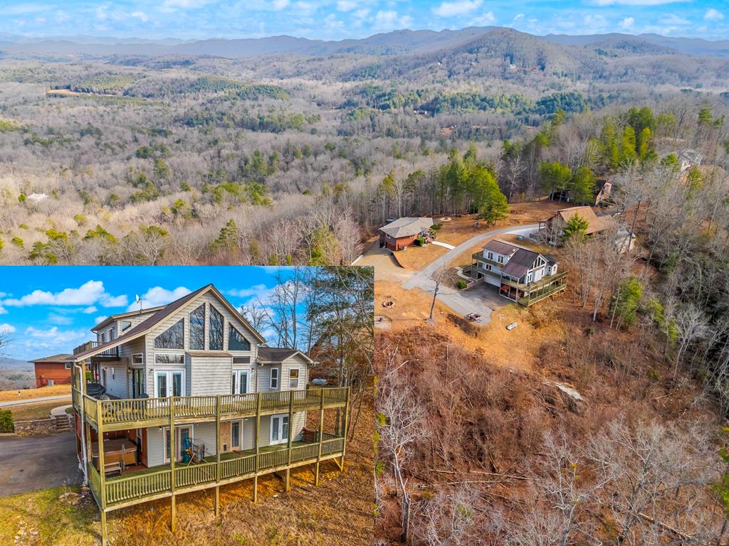 Perched on two combined lots totaling approximately three acres, this stunning 3 bedroom, 3 bathroom mountain home offers privacy, space, and breathtaking long-range MOUNTAIN VIEWS! Located at the end of a paved road with a paved driveway, the setting is both peaceful and easily accessible. Outdoor living is exceptional, with three levels of decks and porches wrapping three sides of the home, perfectly positioned to take in the surrounding scenery. A basement-level garage adds convenience and functionality. Step inside to the dramatic Great Room, where wood floors, a vaulted tongue and groove ceiling, and chalet windows create a warm first impression. A gas log fireplace with a live-edge log mantel anchors the space, while three sets of glass doors open directly to the deck and those sweeping mountain views. Just beyond, the spacious dining room flows seamlessly for effortless entertaining. The open kitchen features two-toned cabinetry, granite countertops, and included appliances, offering both style and practicality. A hallway leads to a full guest bathroom and two generously sized guest bedrooms, each with its own door opening to the porch for easy indoor-outdoor living. Upstairs, a loft catwalk overlooks the Great Room and leads through French doors into the luxurious Master Suite. This private retreat boasts wood floors, a vaulted tongue and groove ceiling, a large walk-in closet, and three sets of doors opening to the deck. The en suite bath includes a double vanity and a custom tile walk-in shower. The lower level offers multiple separate spaces with unlimited potential, along with a laundry area, a full bathroom, and three sets of doors leading outside. Fixed wireless high-speed internet, a fire pit, a hot tub, instant hot water tank, central vacuum system, and—of course—those unforgettable mountain views complete this exceptional escape.