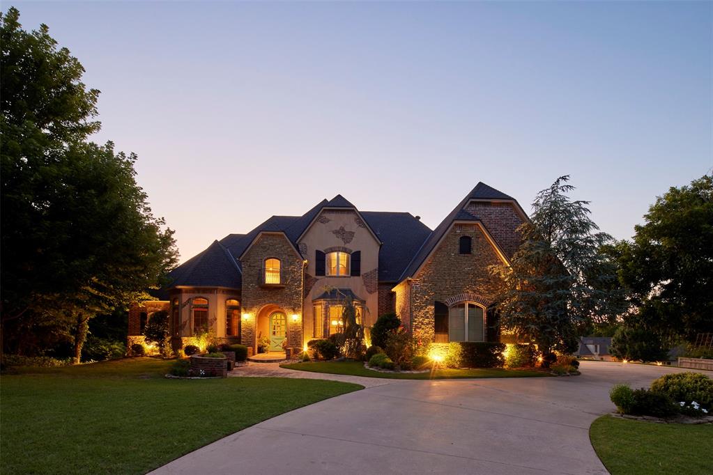 Nestled on a rare .77-acre corner lot in East Edmond’s sought-after Creek Bend neighborhood, this stunning Old English Tudor exudes timeless elegance and exceptional craftsmanship. Mature landscaping and a stately presence set the tone for the grandeur within. Upon entering the home, you’re welcomed into a dramatic foyer with soaring 20-foot ceilings and a sweeping custom iron staircase, flanked by a richly appointed formal study and a refined dining room. The study is a true showpiece, wrapped in floor-to-ceiling stained woodwork and featuring a built-in desk, bookshelves, and a hidden door leading to a private desk area with discreet access to the primary suite. The dining room is graced with custom wood moldings and a charming bay window overlooking the manicured front lawn. The chef’s kitchen is a dream for both everyday living and entertaining, outfitted with double ovens, a gas range, a full-size Meile refrigerator and freezer, and a built-in ice maker. A Butler’s pantry with custom cabinetry connects seamlessly to the formal dining space, adding to the home's effortless flow. The main living room, with its warm stone fireplace and backyard views, opens to a spacious game room complete with a bar and a private theater. With a total of 6 living areas throughout, there is space for everyone and every occasion. The luxurious primary suite offers a serene retreat with treetop views, dual vanities, a makeup vanity, jetted soaking tub, oversized walk-in shower, and an expansive walk-in closet. Upstairs, you’ll find 3 generously sized bedrooms, each with its own en suite bathroom and abundant walk-in closets. The walkout basement adds even more versatility with it's perfectly suited playroom with a built-in desk, a workout room, an additional bedroom with an en suite bath and provides access to an indoor sports court ideal for tennis, pickleball, or basketball. This extraordinary home blends luxury, functionality, and entertainment in one impressive home.