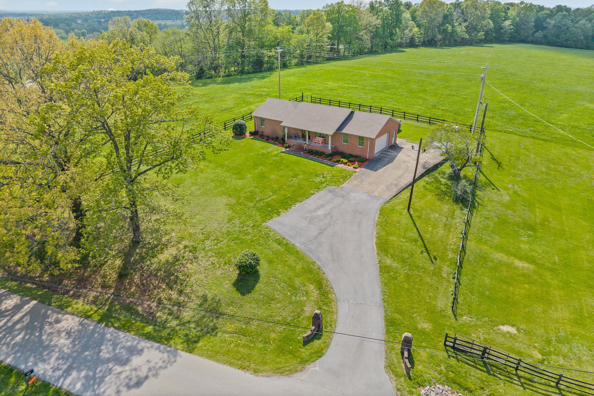 Experience country living at its finest on this beautiful 28‑acre farm featuring a well‑maintained 1,590 sq ft all‑brick home built in 1996. The property offers exceptional functionality for farming, horses, equipment storage, or homesteading.The home features an open floorplan, bar overlooking the living room, fireplace, dedicated laundry area, attached 2‑car garage, rear deck, and a covered dog pen. A 20×30 detached garage is fully finished and insulated—perfect for a workshop or additional storage. The paved driveway and updated landscaping add to the home’s curb appeal.The main tract includes 24 acres of pasture with three full gates, ideal for livestock or hay. Across the road, an additional 4‑acre fenced parcel includes horse fencing, a gated entrance, and a standing tobacco barn.Farm structures include a 50×60 multipurpose barn, a 4‑stall horse barn with tack room, a covered lean‑to for supplies, and a separate equipment lean‑to for tractors or implements. This property offers everything needed for a working farm or private retreat. HVAC- 5 years old, water heater- 8 years Roof-3 yearsA must‑see property with endless potential.