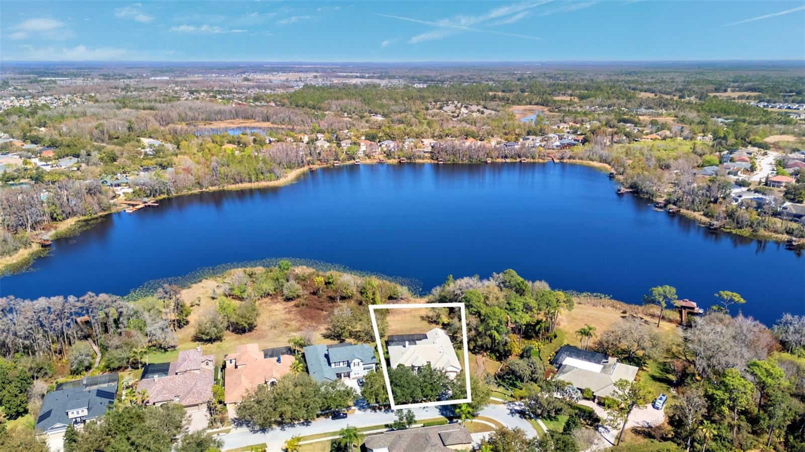 Opportunities like this do not come around often.Built by renowned custom builder Hannah Bartoletta Homes, this one owner lakefront estate sits on an oversized .54 acre lot in the gated Waters Edge section and is one of the very few homes in the entire community positioned directly on Bay Lake.With nearly 4,000 square feet of living space, this residence offers 4 bedrooms, 3.5 baths, a dedicated office, formal living room, expansive family room, breakfast nook, and a large bonus or game room. The layout was designed for both entertaining and everyday comfort, with generous room sizes, high ceilings, and natural light throughout.Step outside to a screened pool and spa overlooking the lake and conservation backdrop. The setting delivers privacy, open water views, and access to one of the most peaceful lakes in the area where motorboats are not permitted. For those wanting even more connection to the water, the new owner has the option to build a private dock. The home is also located adjacent to the Waters Edge park and community dock extending onto the lake.This property presents a rare opportunity to own a true lakefront estate in a gated enclave and personalize it to your taste. The pool and spa are ready for refinishing, offering the next owner the chance to modernize and elevate the outdoor space to match their vision.Lakefront properties in Waters Edge are extremely limited. When they come available, they do not last.If you have been waiting for a statement property on Bay Lake, this is your chance.